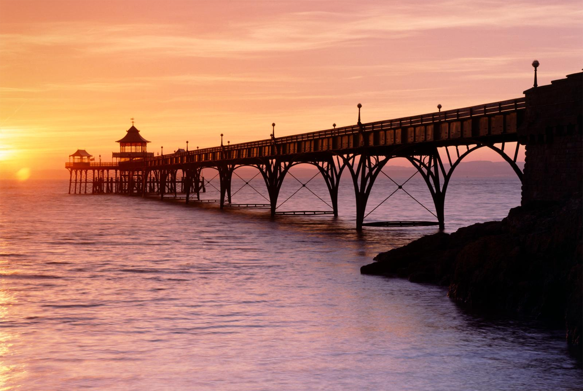A view of Clevedon pier at sunset.