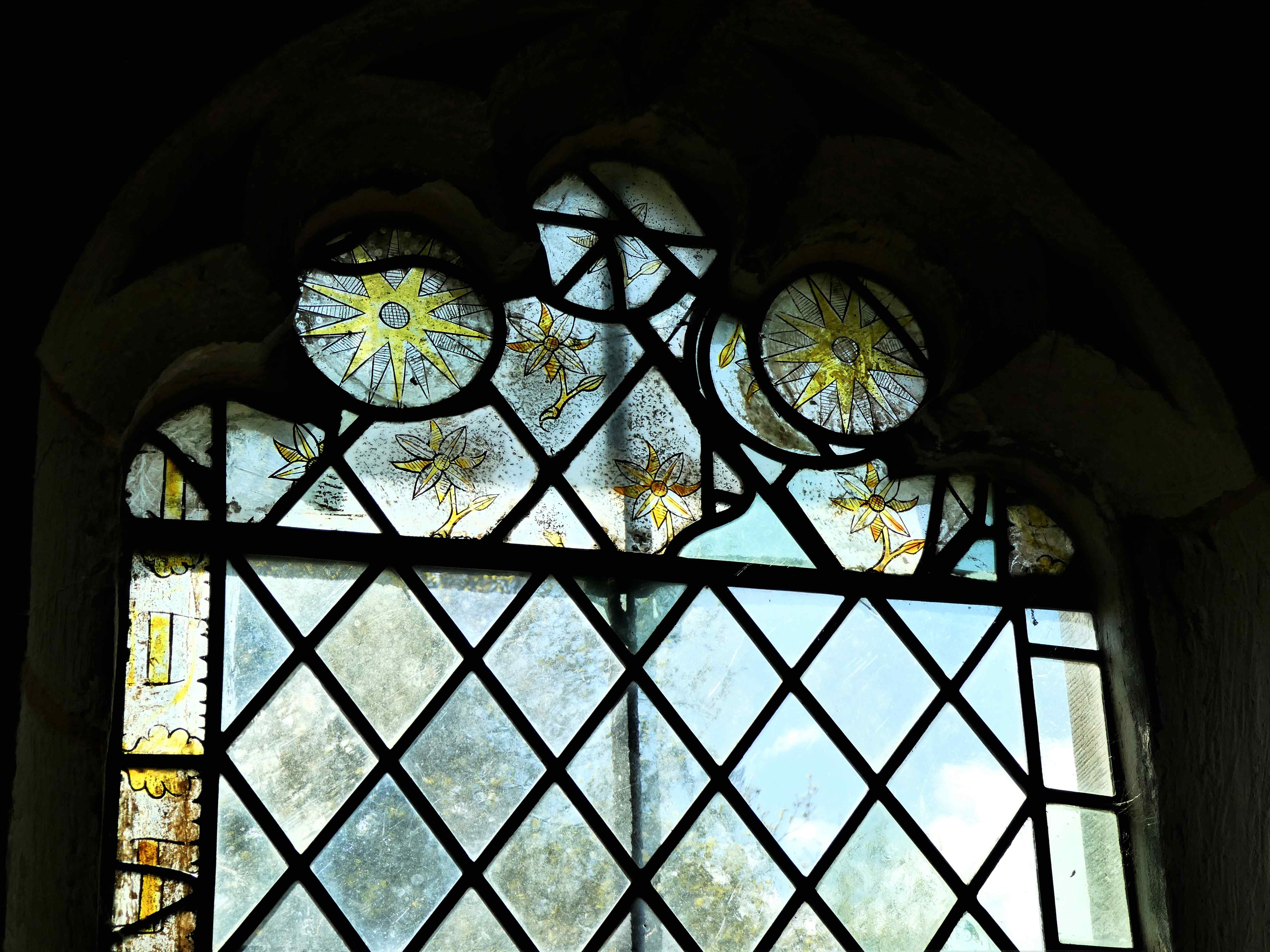 A close-up image showing a sanctuary window with stained glass planes.