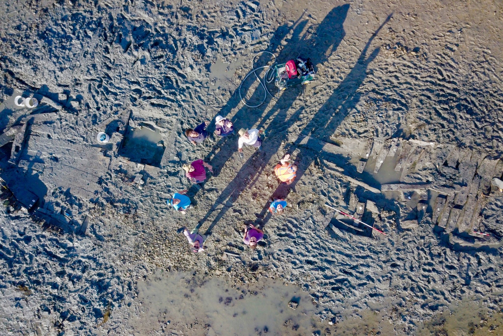 Aerial image of the early-18th century wreck of the Old Brig emerging from mud and sand of the Thames Estuary at Seasalter, north Kent.