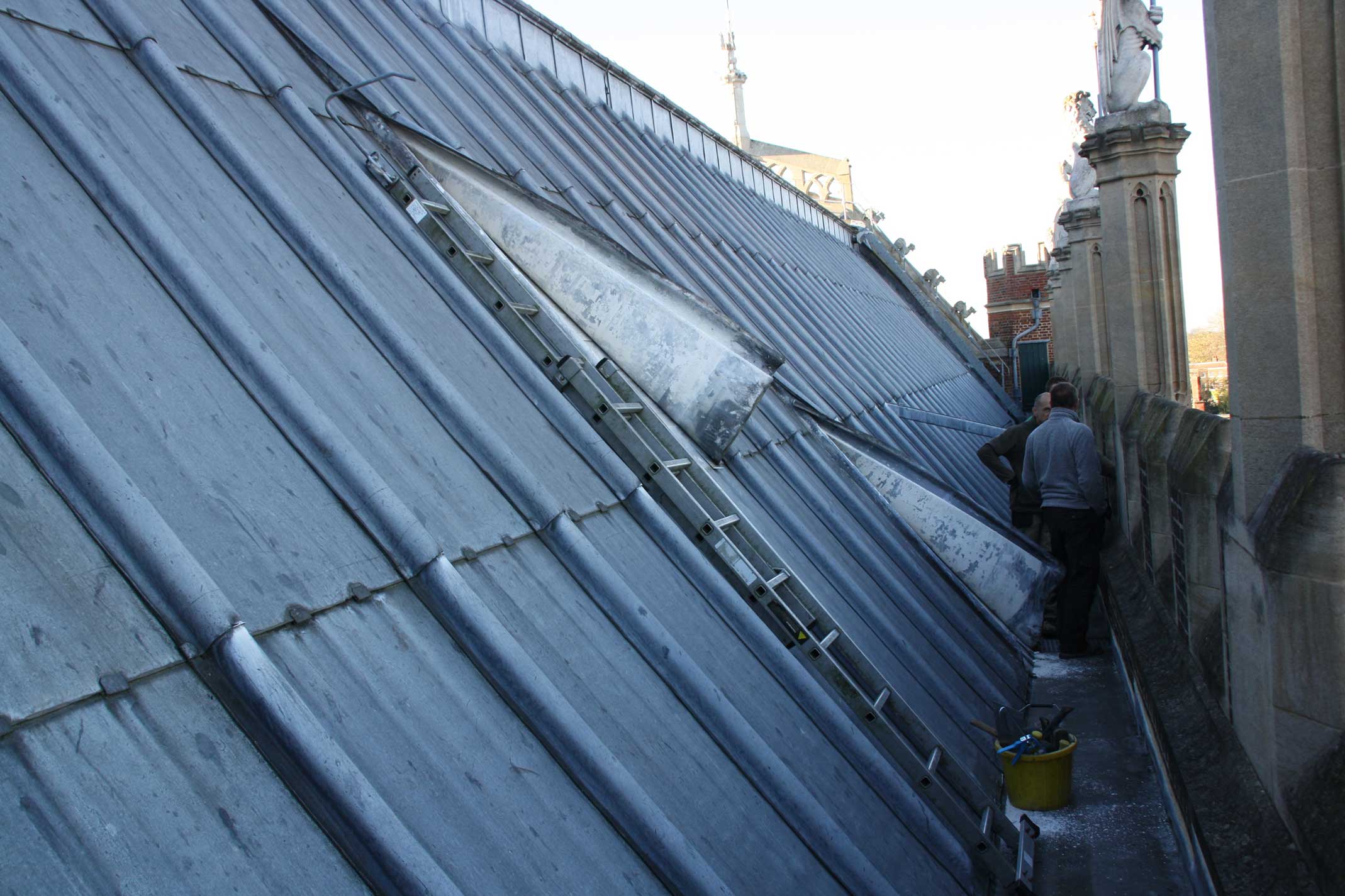 A lead roof being inspected by conservation staff.