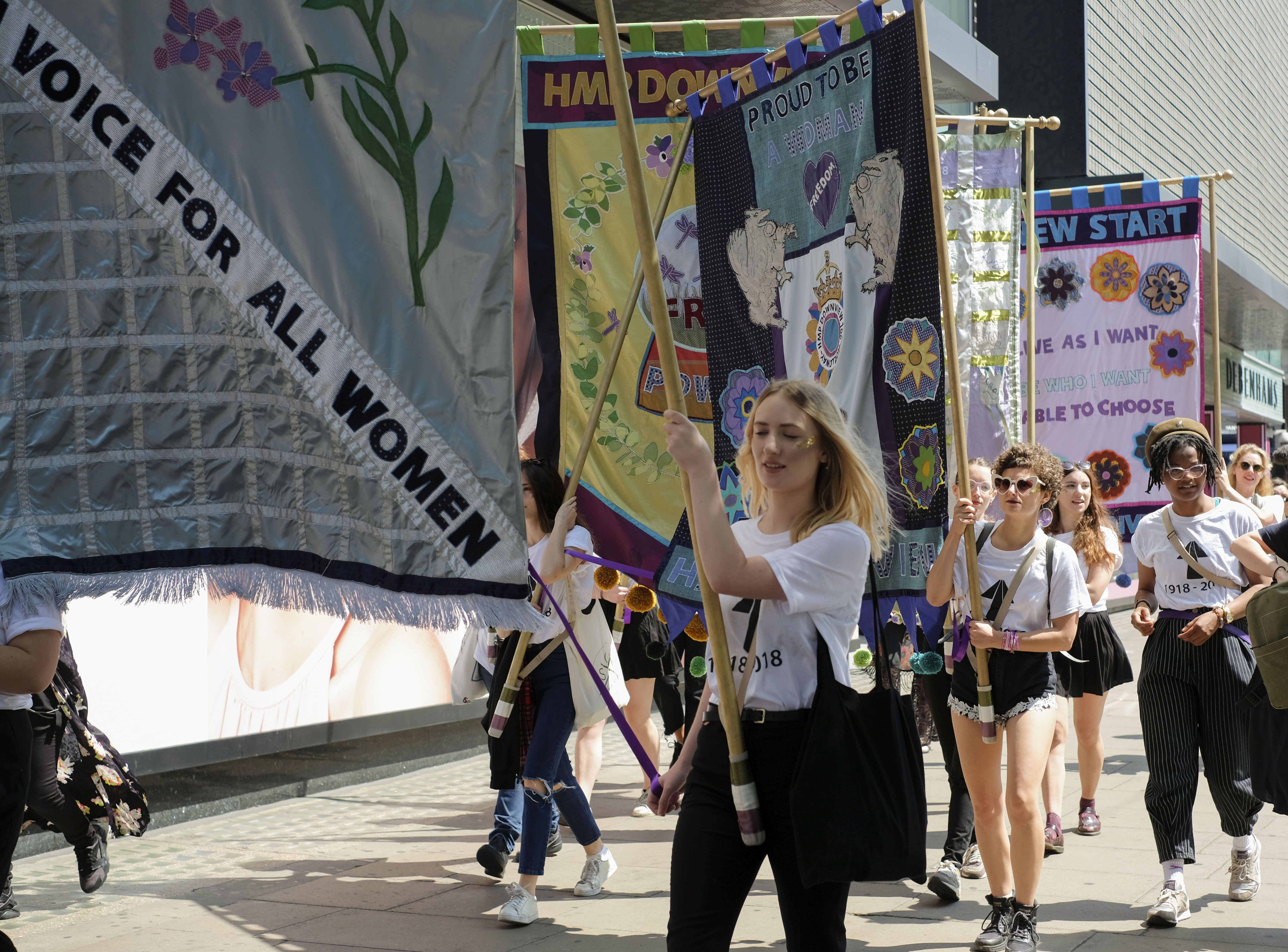 London College of Fashion students march with the banners in the sunshine.