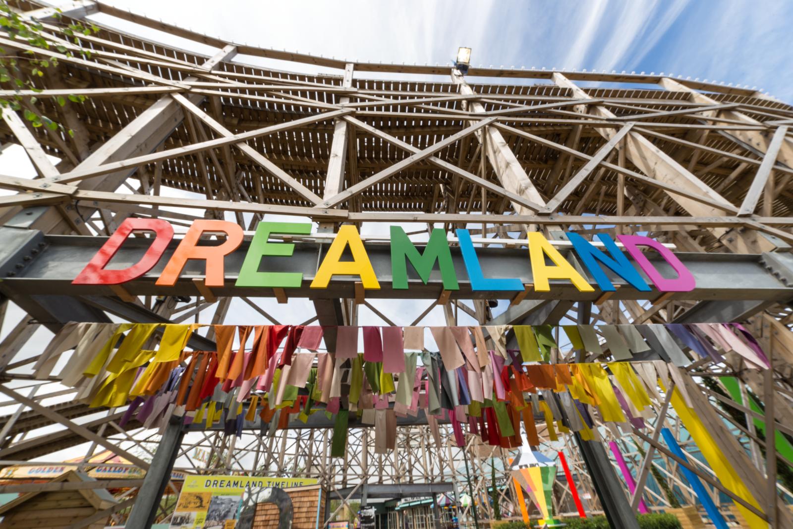 The sign above the entrance to Dreamland in Margate. Each letter in the banner is a different colour. In the background is the structure of the rollercoaster.
