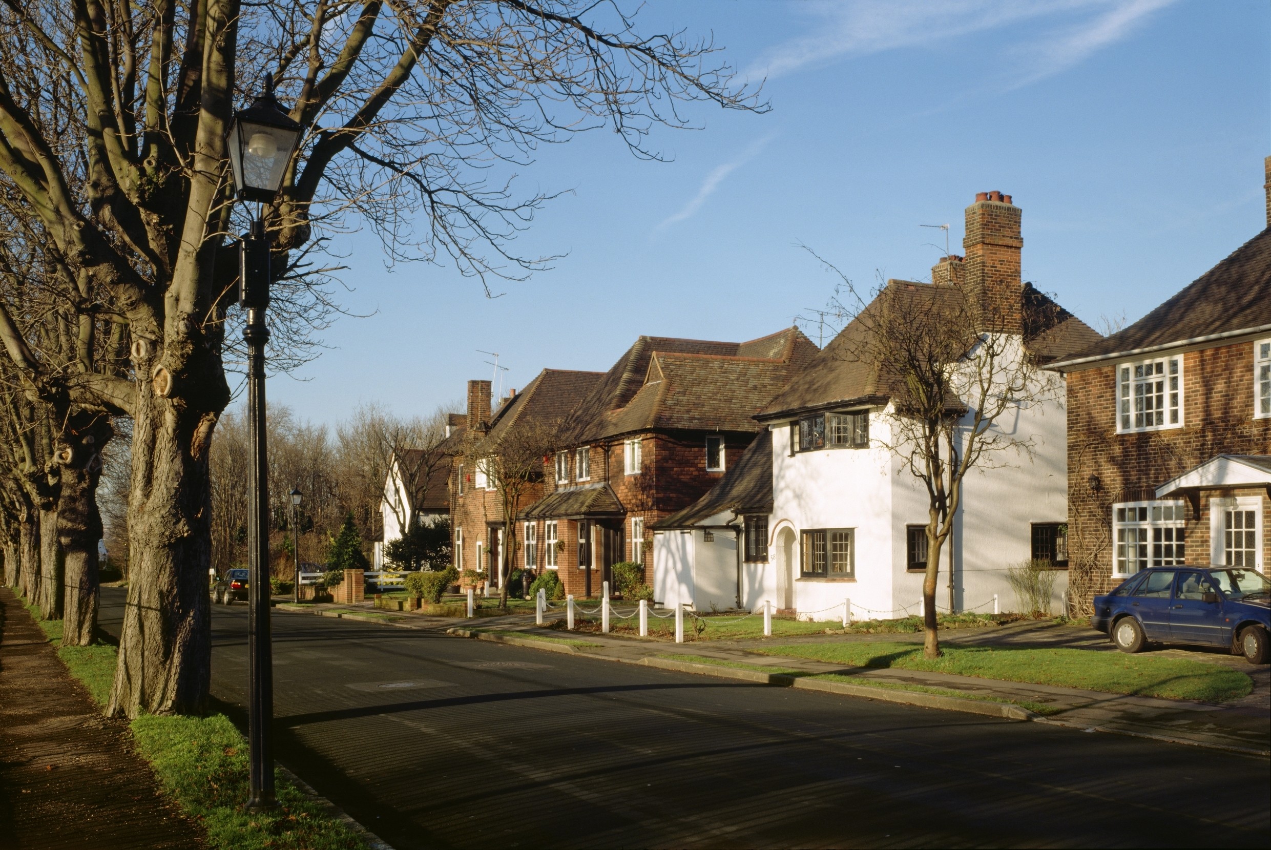 Sub-urban street lined with trees in Gidea Park conservation area, London Borough of Havering