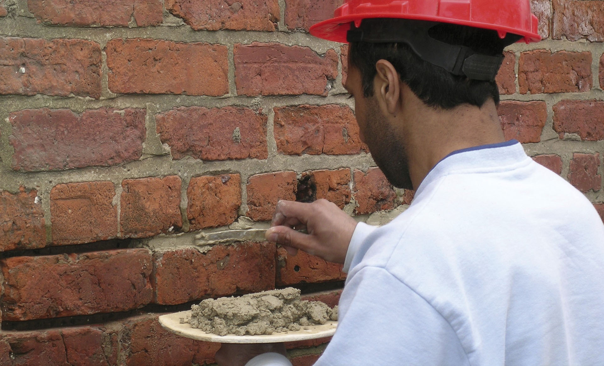 Man repointing brickwork