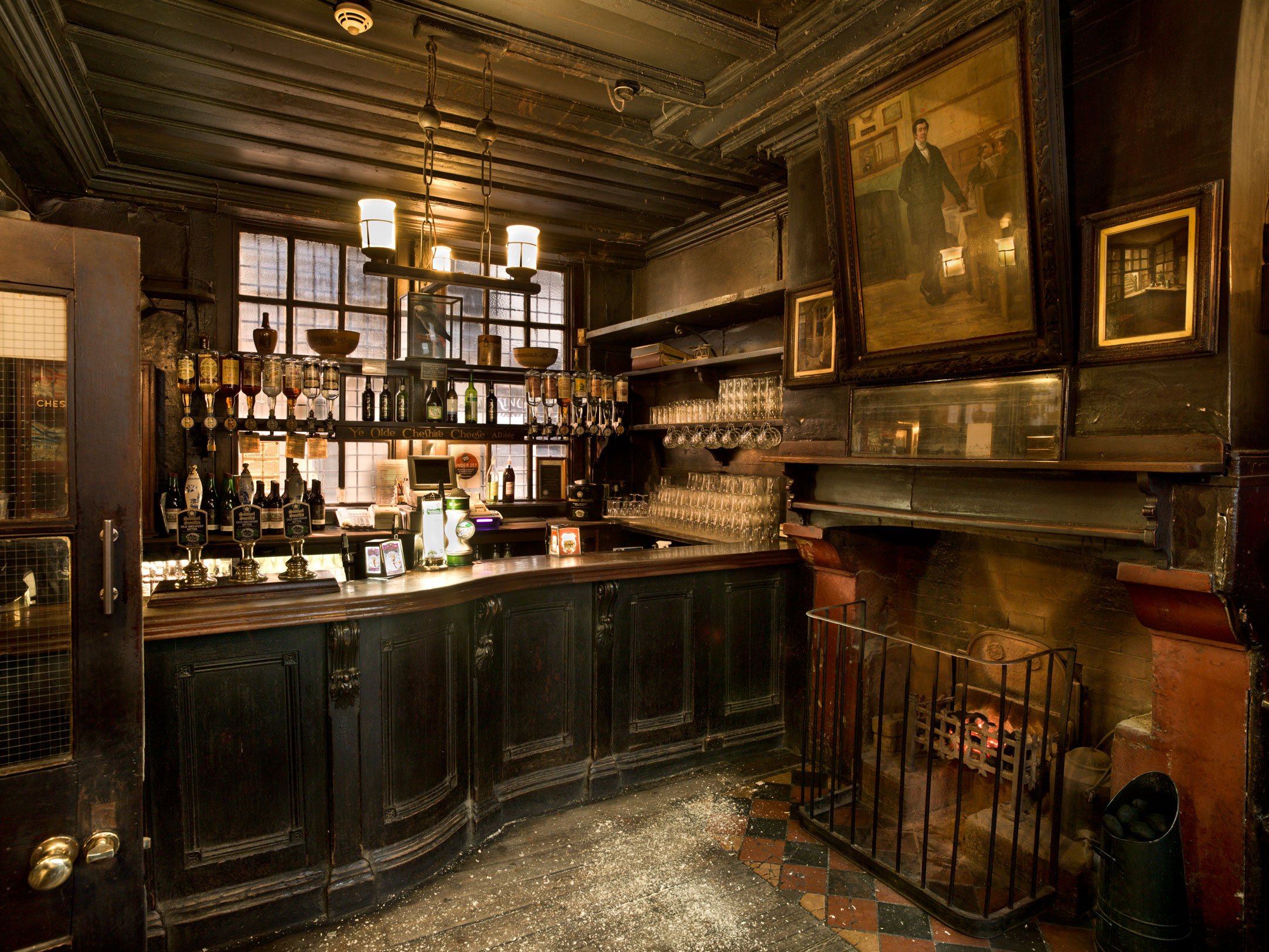 An interior detail of a bar area and fire place within a historic London public house.