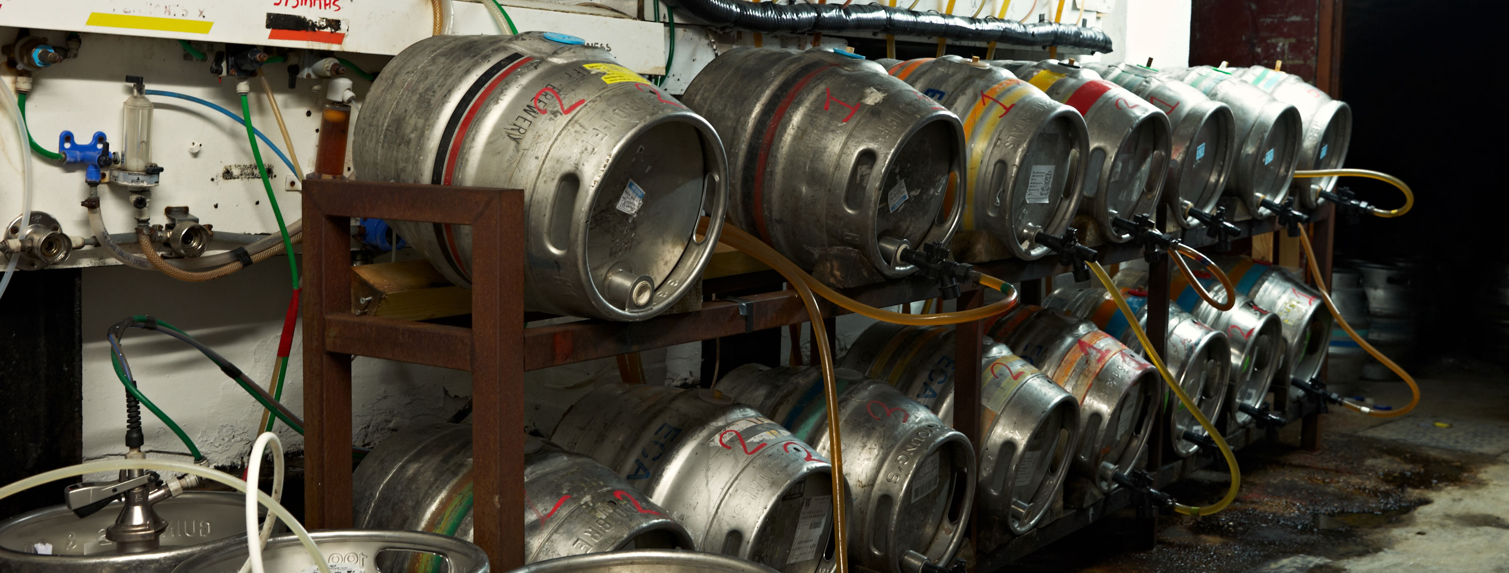 Rows of beer kegs stored in the back of a pub