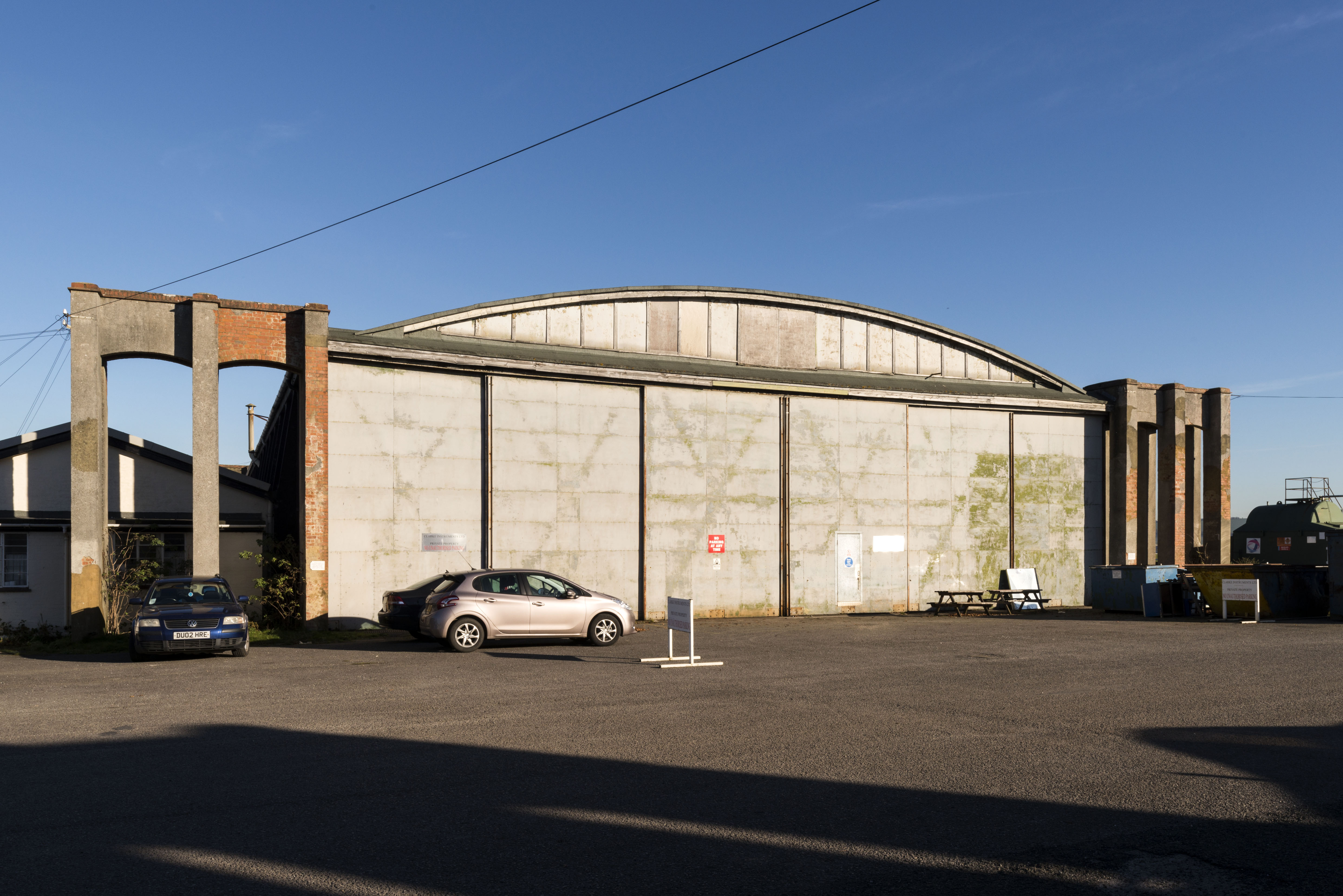 Image of the exterior of a historic aircraft hangar, a large single story building