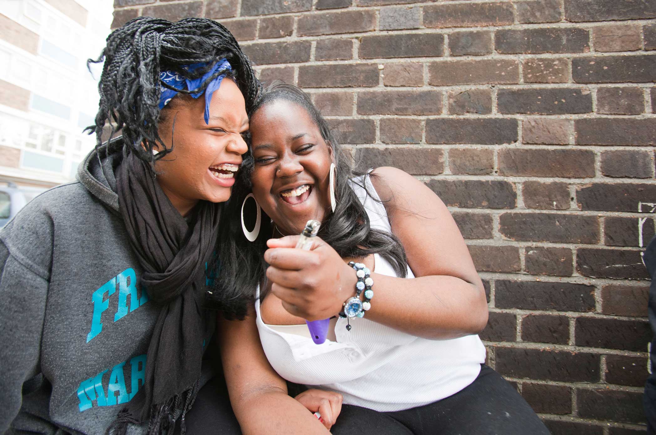 Two Black girls laughing together
