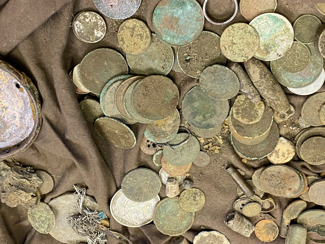 Collection of coins covered with dirt