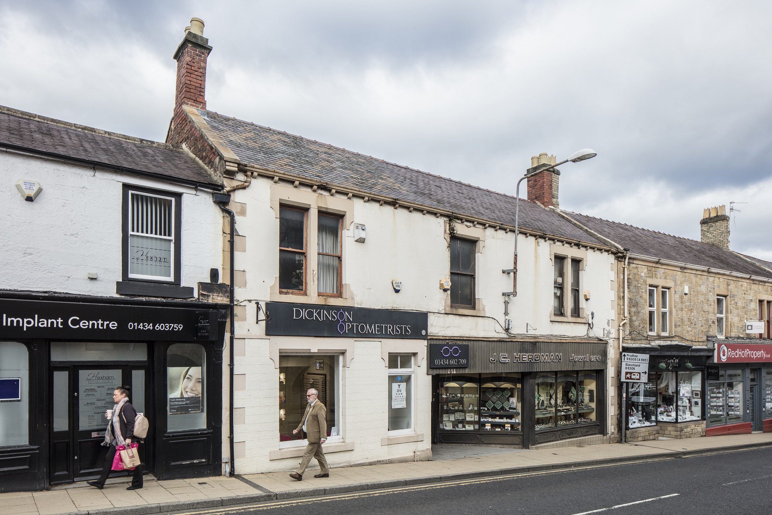 Hexham High Street Heritage Action Zone. 2019.Dickinson Optometrists and J.C.Herdman Jewellers,15 Battle Hill/ Priestpopple, Hexham, Northumberland. View from south east.