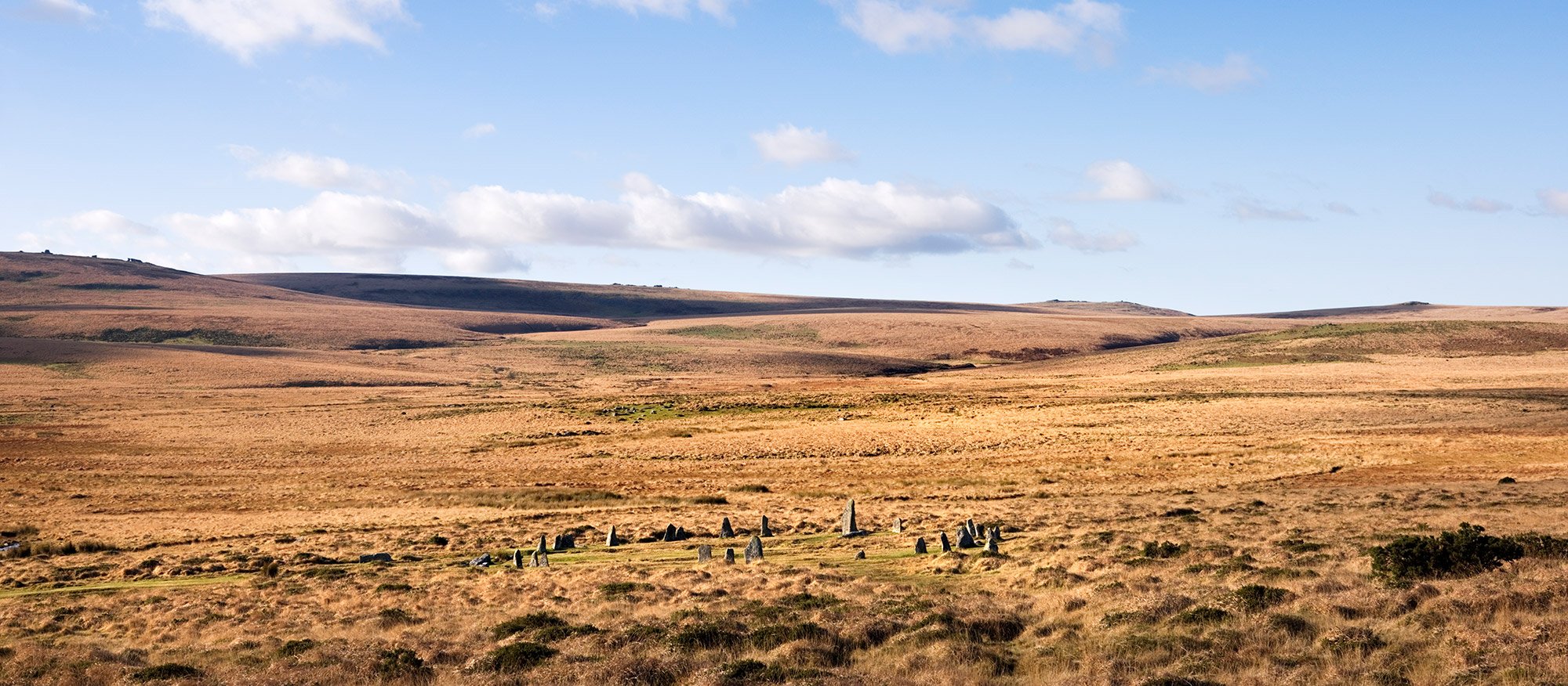 A stone circle in a wide open landscape.