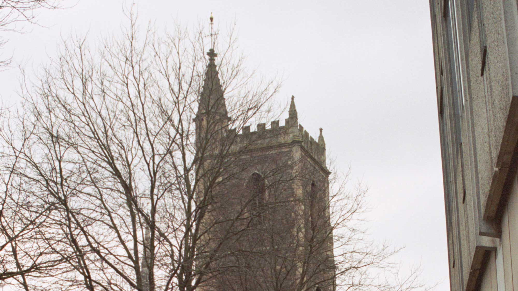 Remains of church tower surrounded by modern buildings
