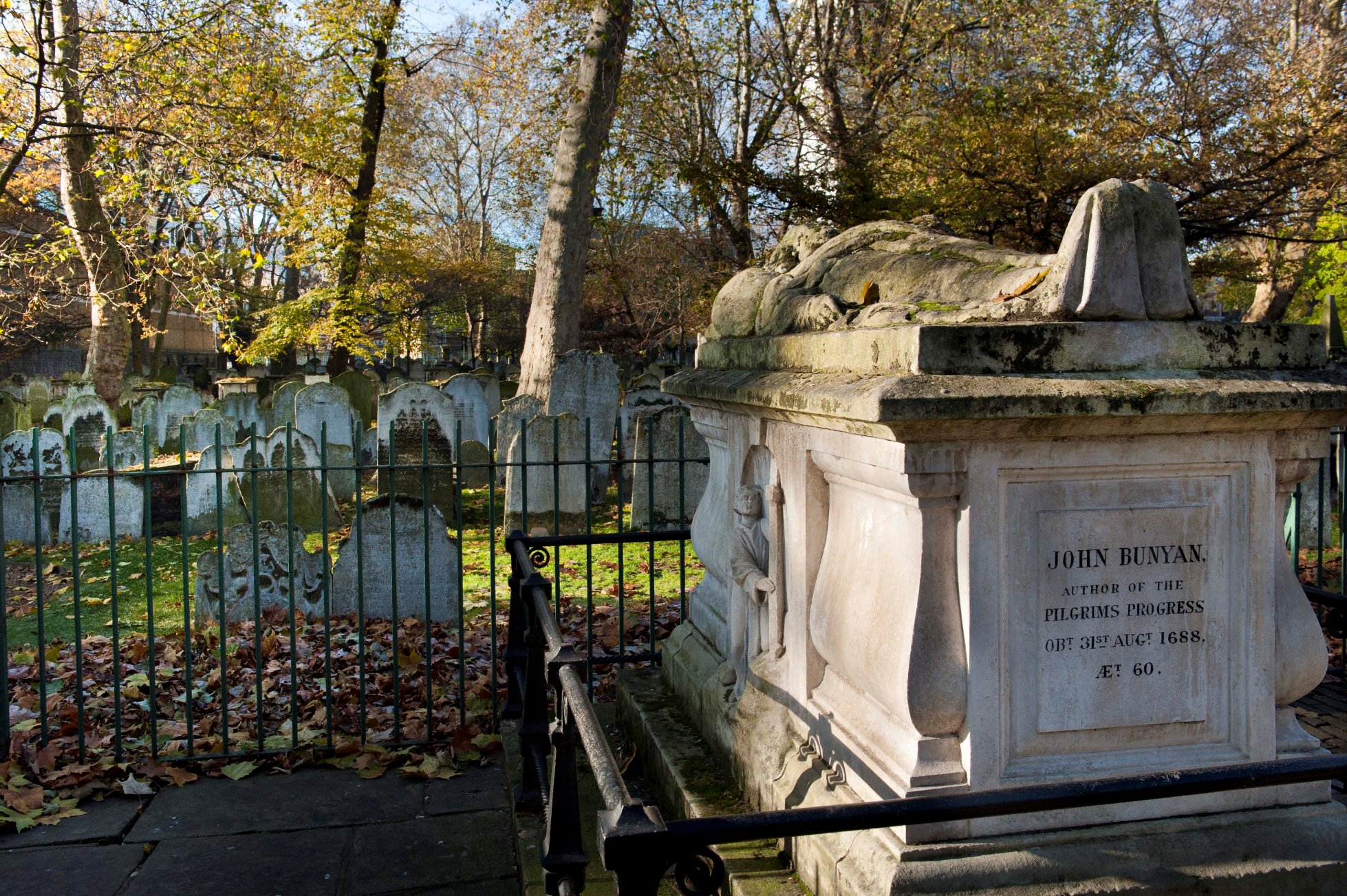 Bunhill Fields Burial Ground, City Road, Islington, London. Exterior showing John Bunyan’s stone-built tomb and gravestones.