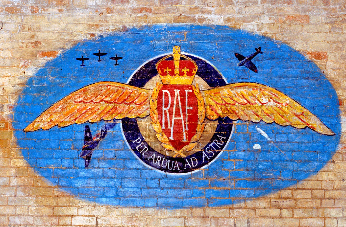 Fowlmere, Cambridgeshire, mural of the winged badge of the Royal Air Force painted on a farm building in preparation for a Christmas party in 1940.