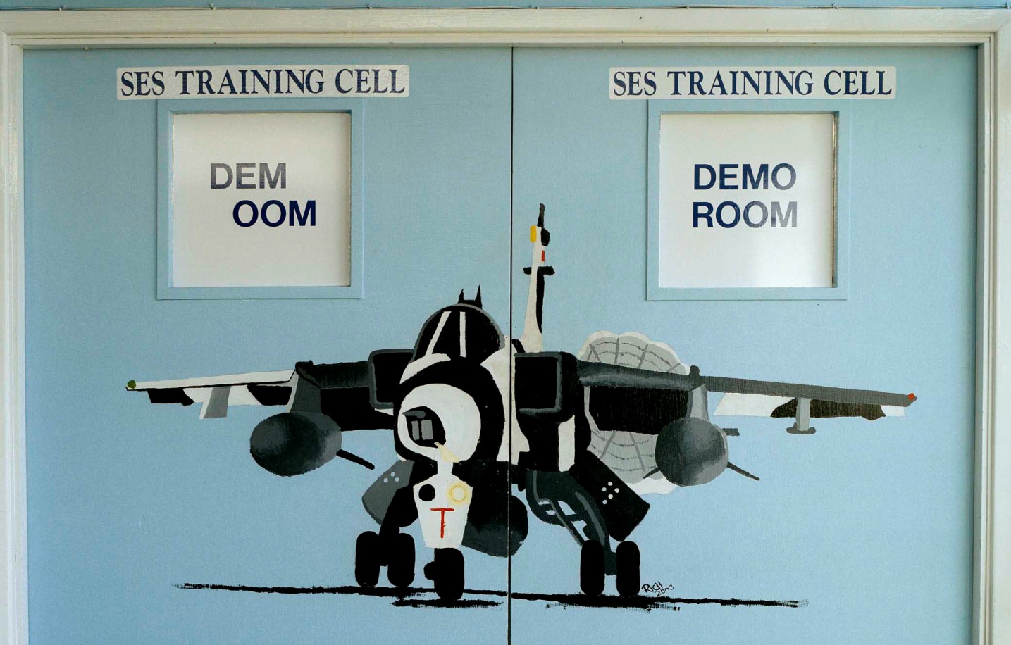RAF Coltishall, Norfolk, a painting of a Jaguar aircraft in winter camouflage on a door.