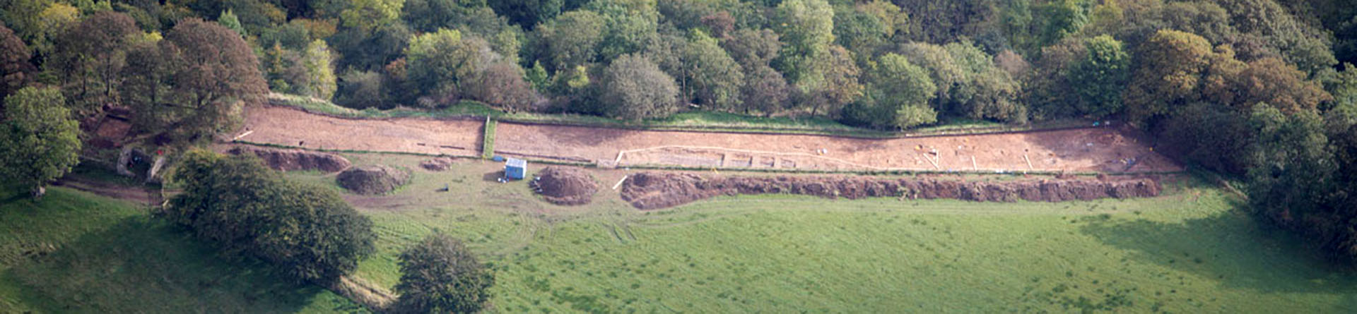 Aerial photograph showing an excavated strip of field at the top of a river cliff at Birdoswald Roman cemetery