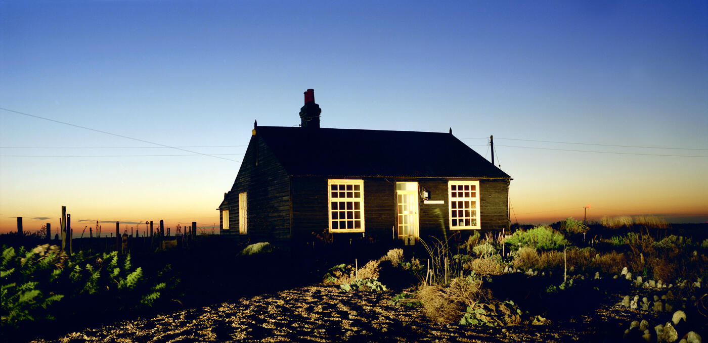 Photo of a small cottage at sunset