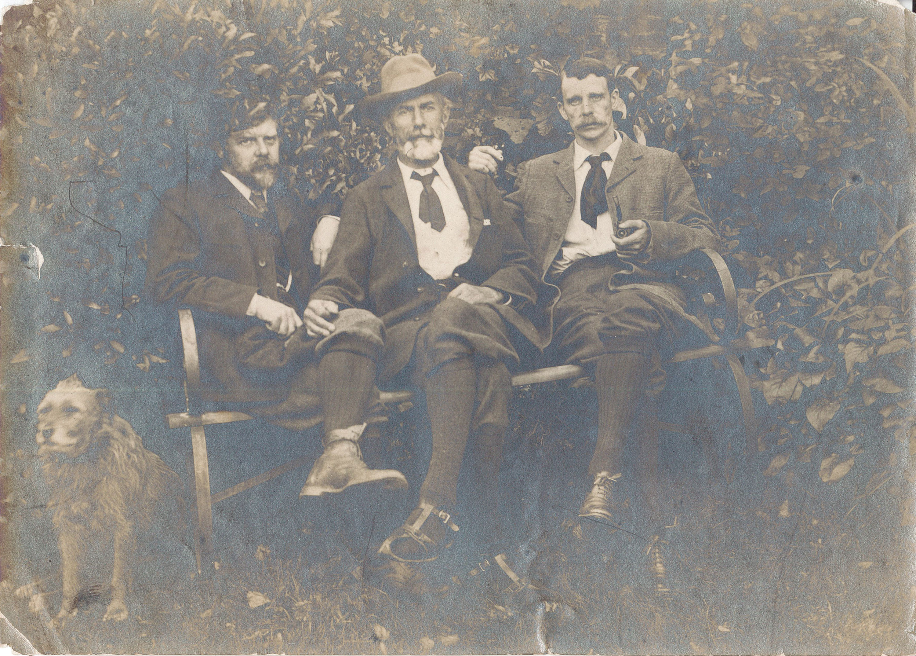 Edward Carpenter, George Merrill, and G. Hukin seated outdoors