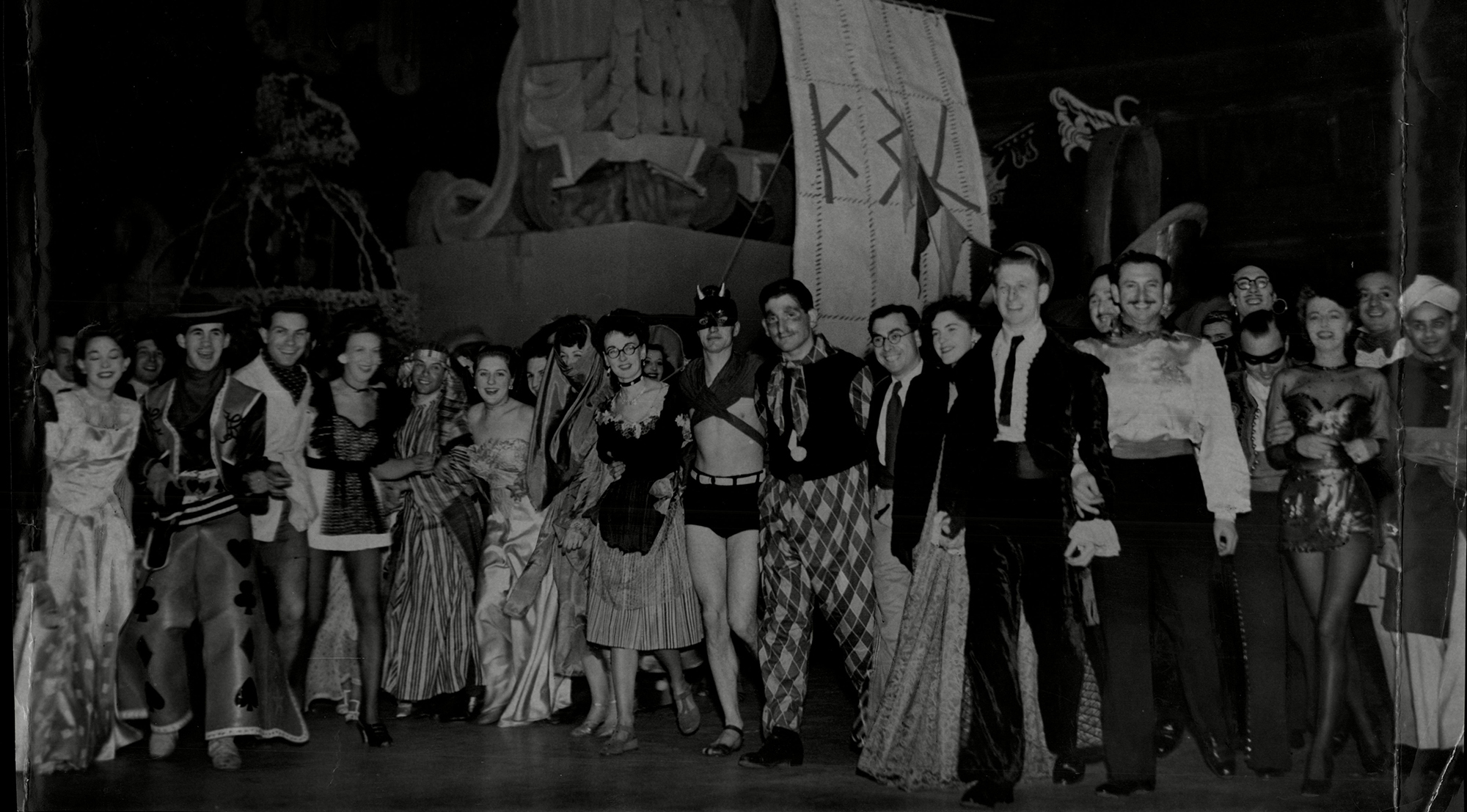 Posed group photo of partygoers in fancy dress at Chelsea Arts Ball at the Royal Albert Hall, New Year's Eve 1946