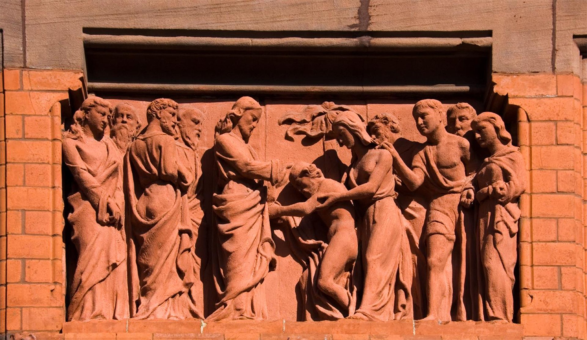 A terracotta panel showing Christ healing a man