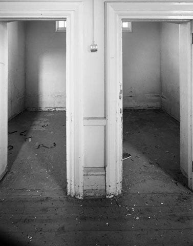 Ground floor, doors to cells east side of Area B, Colney Hatch Asylum, London. 