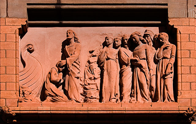 Detail view of a terracotta panel, showing Christ healing a blind man, on the south elevation of the former Liverpool Eye and Ear Hospital.