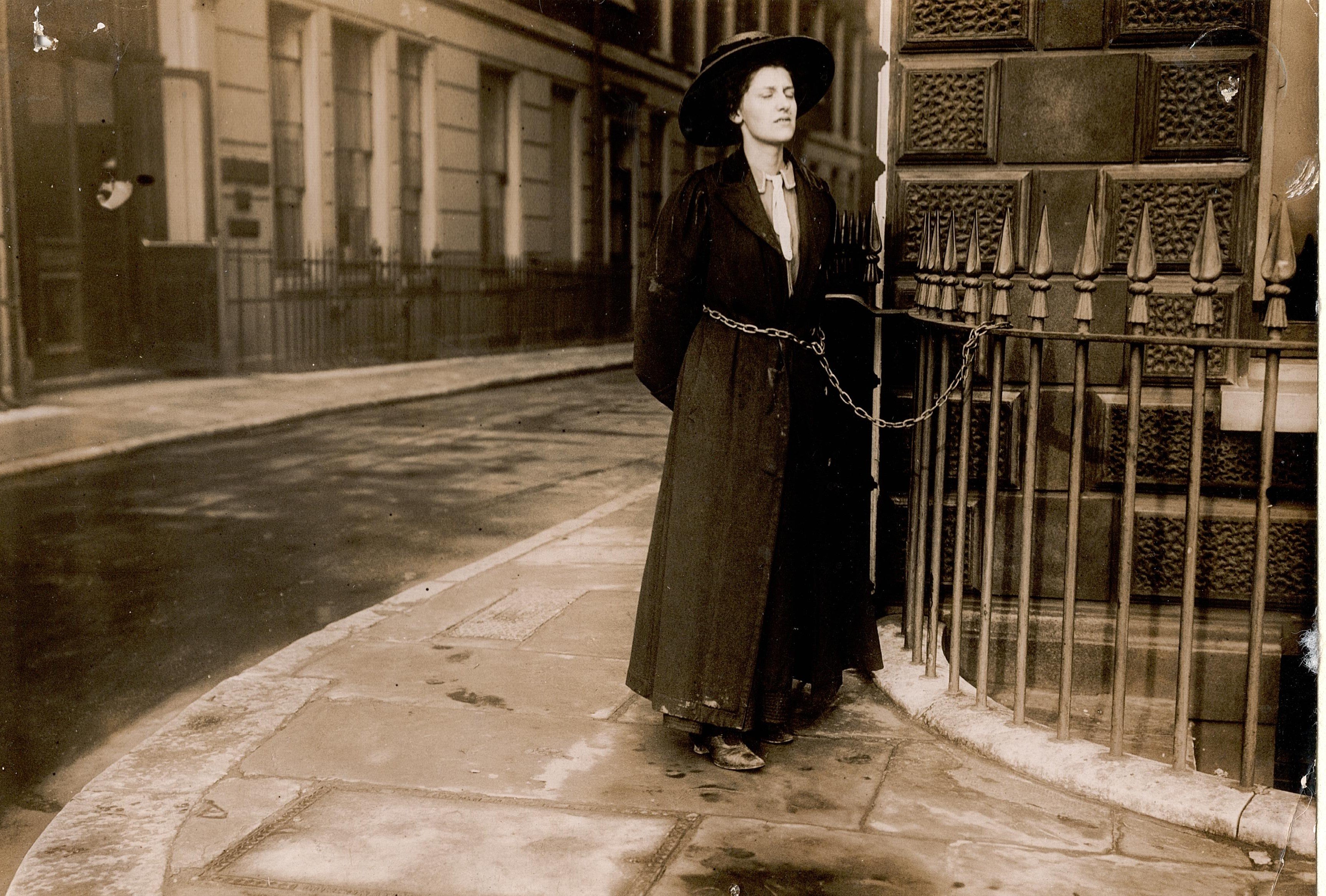 Photograph of a suffragette chained to a railing