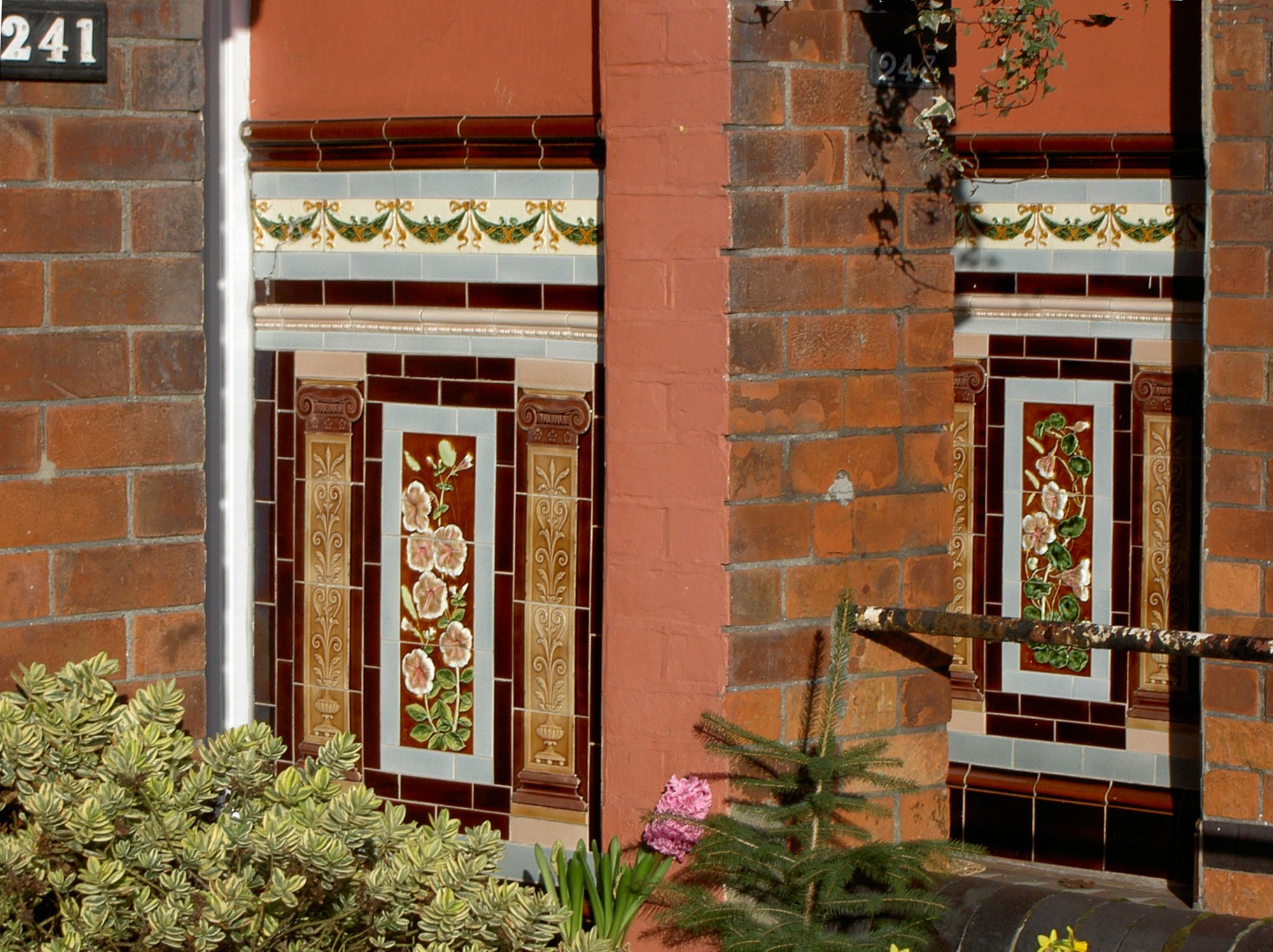 Alternating brick and tiled surfaces with garden plants in foreground.