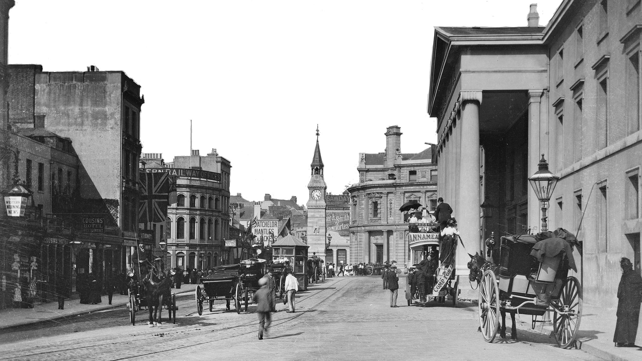 Black and white archive photograph of a busy street scene.