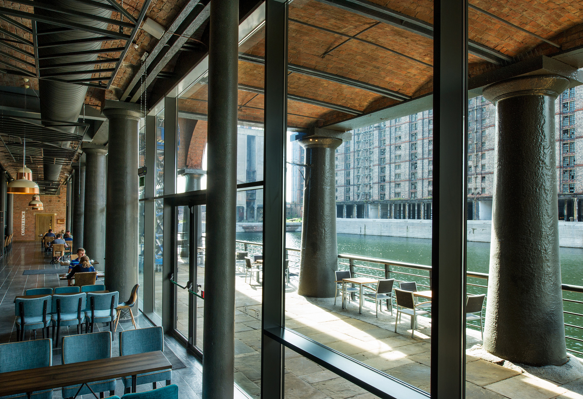 View of a cafe interior and across the dock to other buildings.