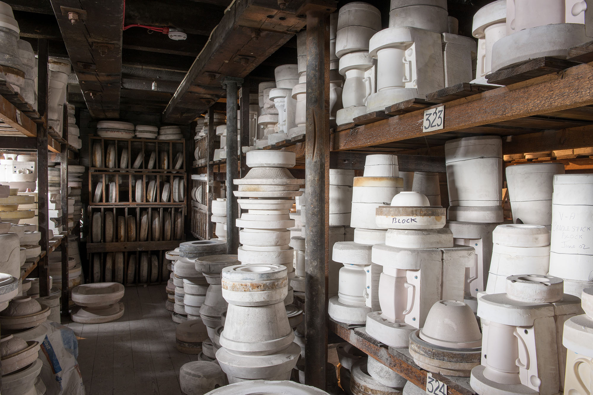 Pottery stacked up on wooden shelves