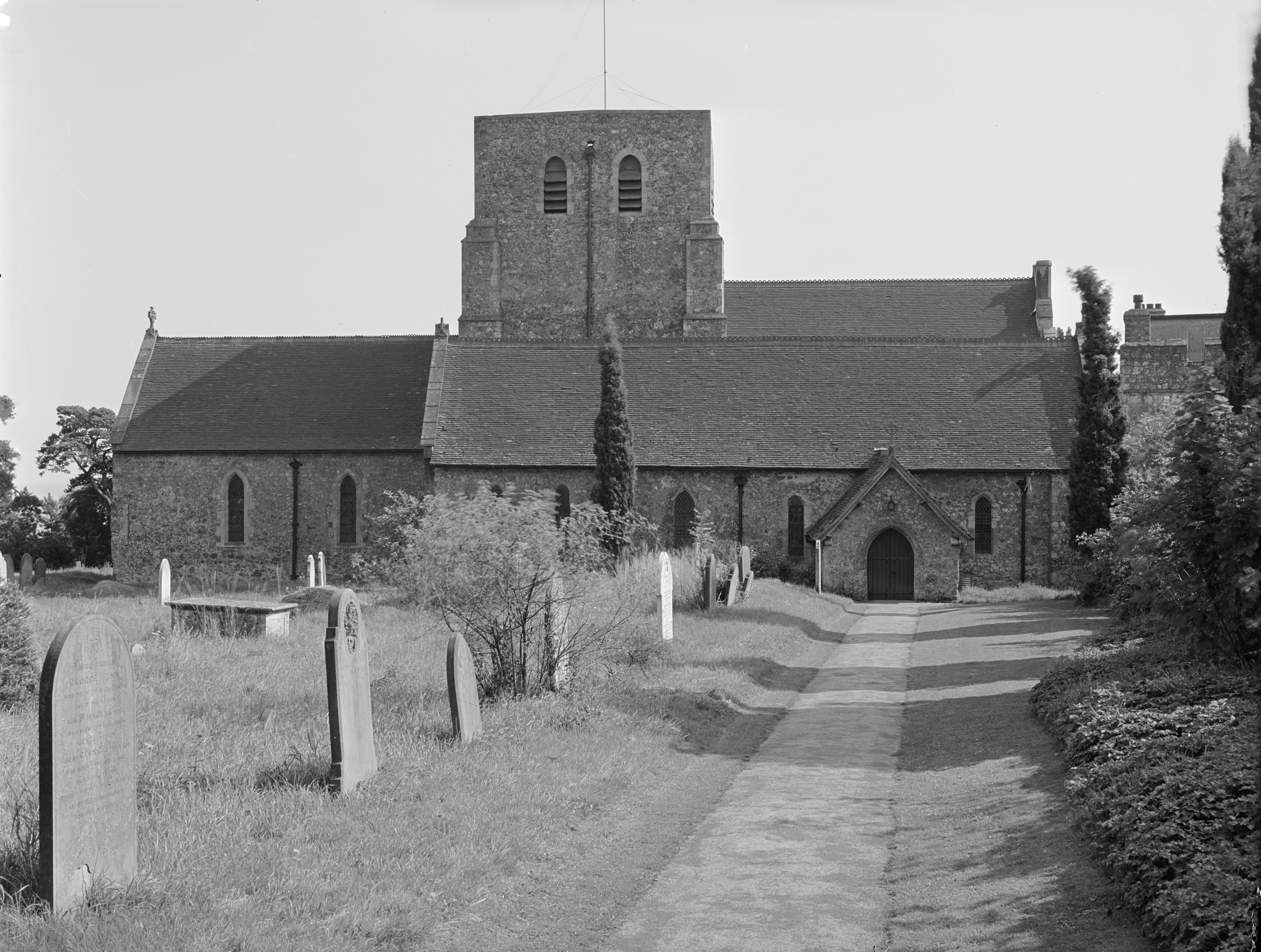 Black and white photo of 14th century church and graveyard.