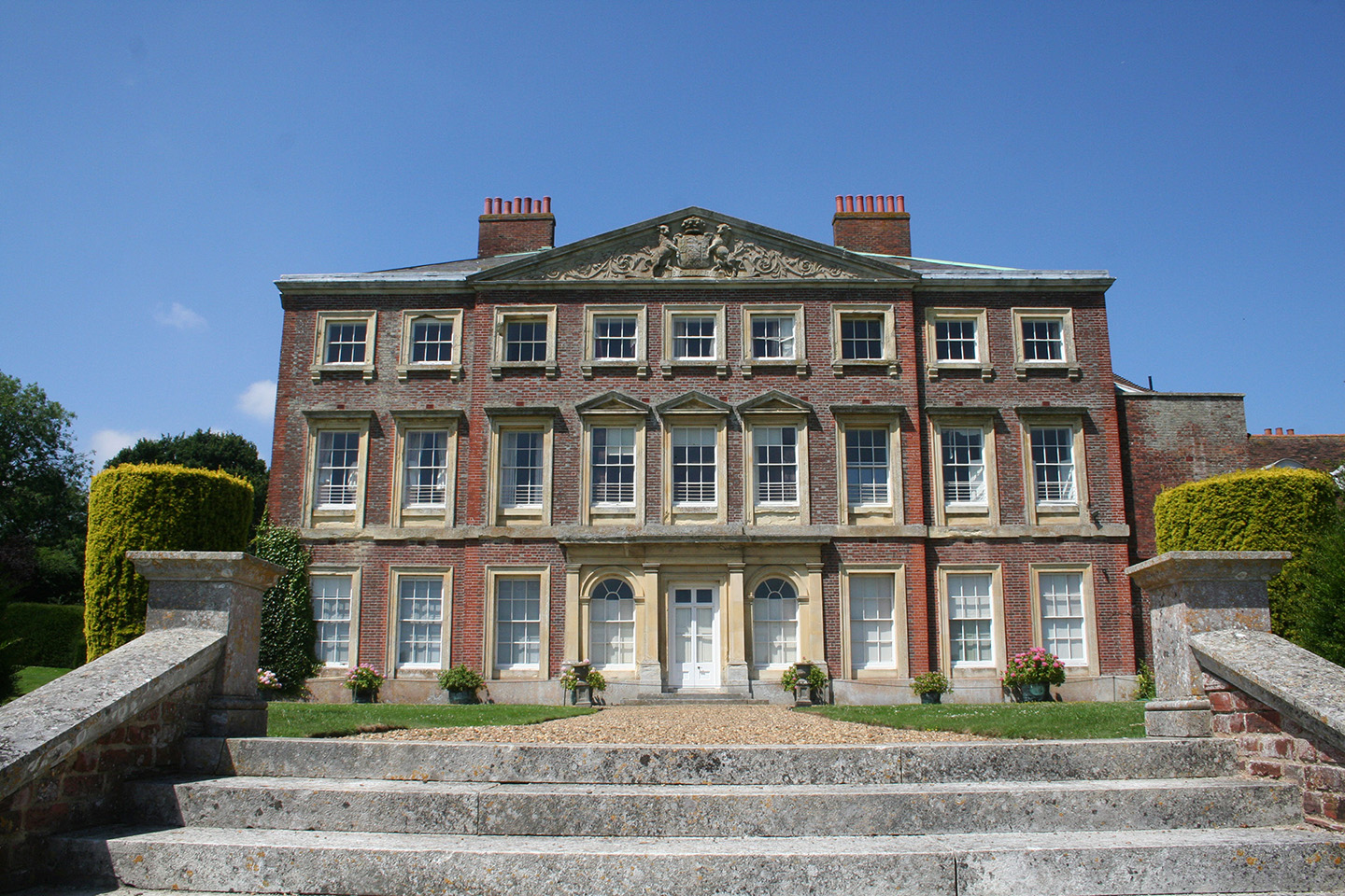 View of the grand brick house with nine windows across and three stories high