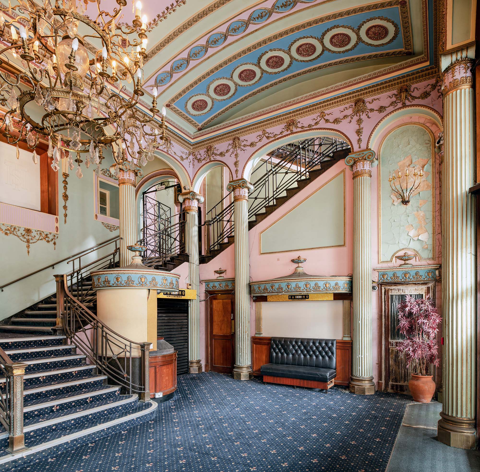 View of the Streatham Hill Theatre foyer with decorated walls, ceiling and chandelier