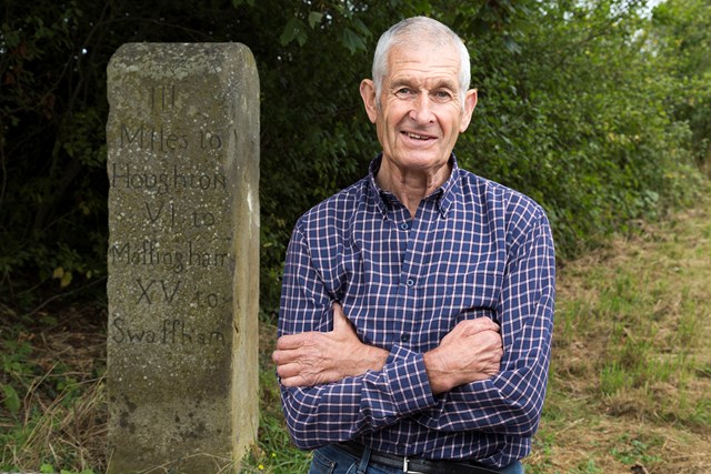 Nigel Ford standing next to a milestone