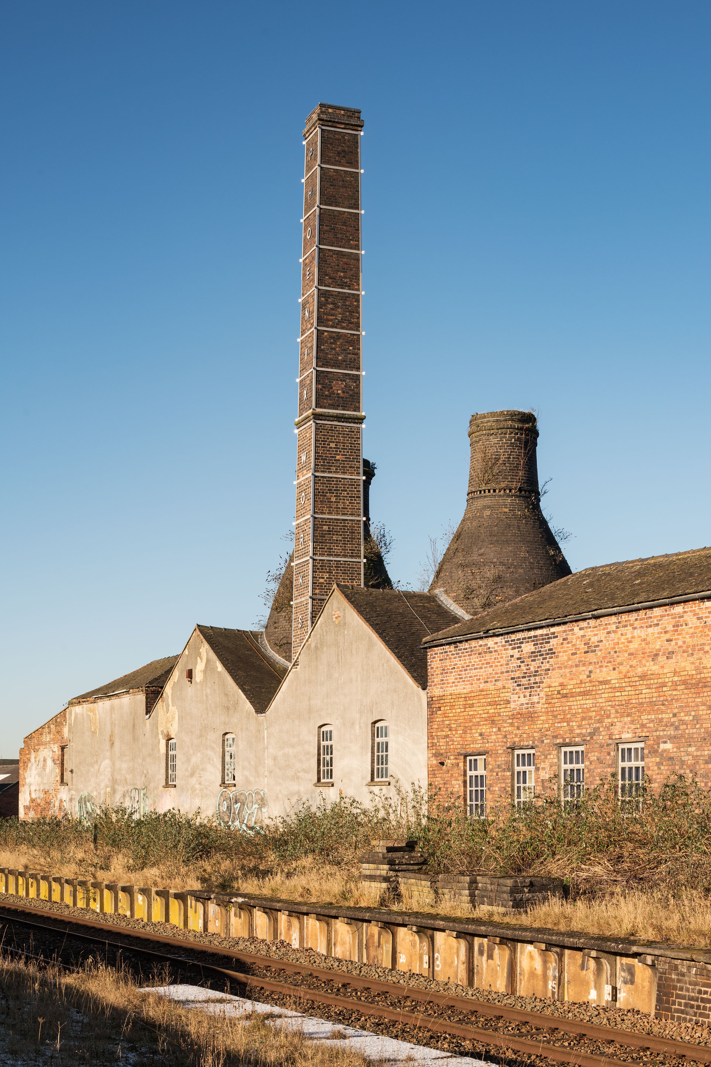 A brick building with a tall chimney