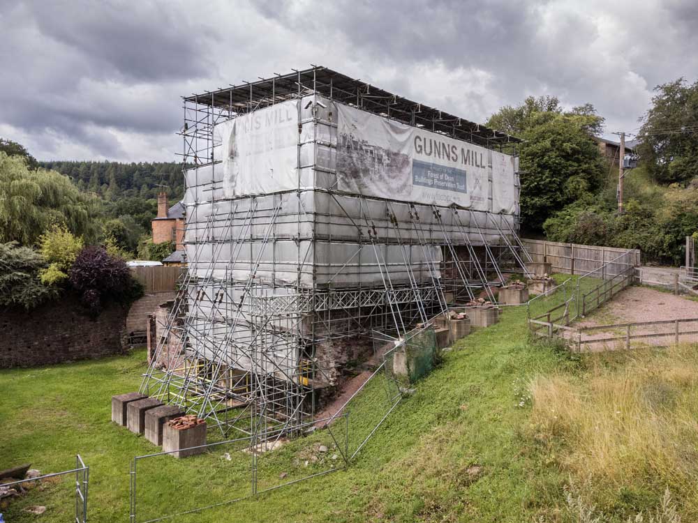 A photograph of a historic building entirely encased in a protective scaffold.