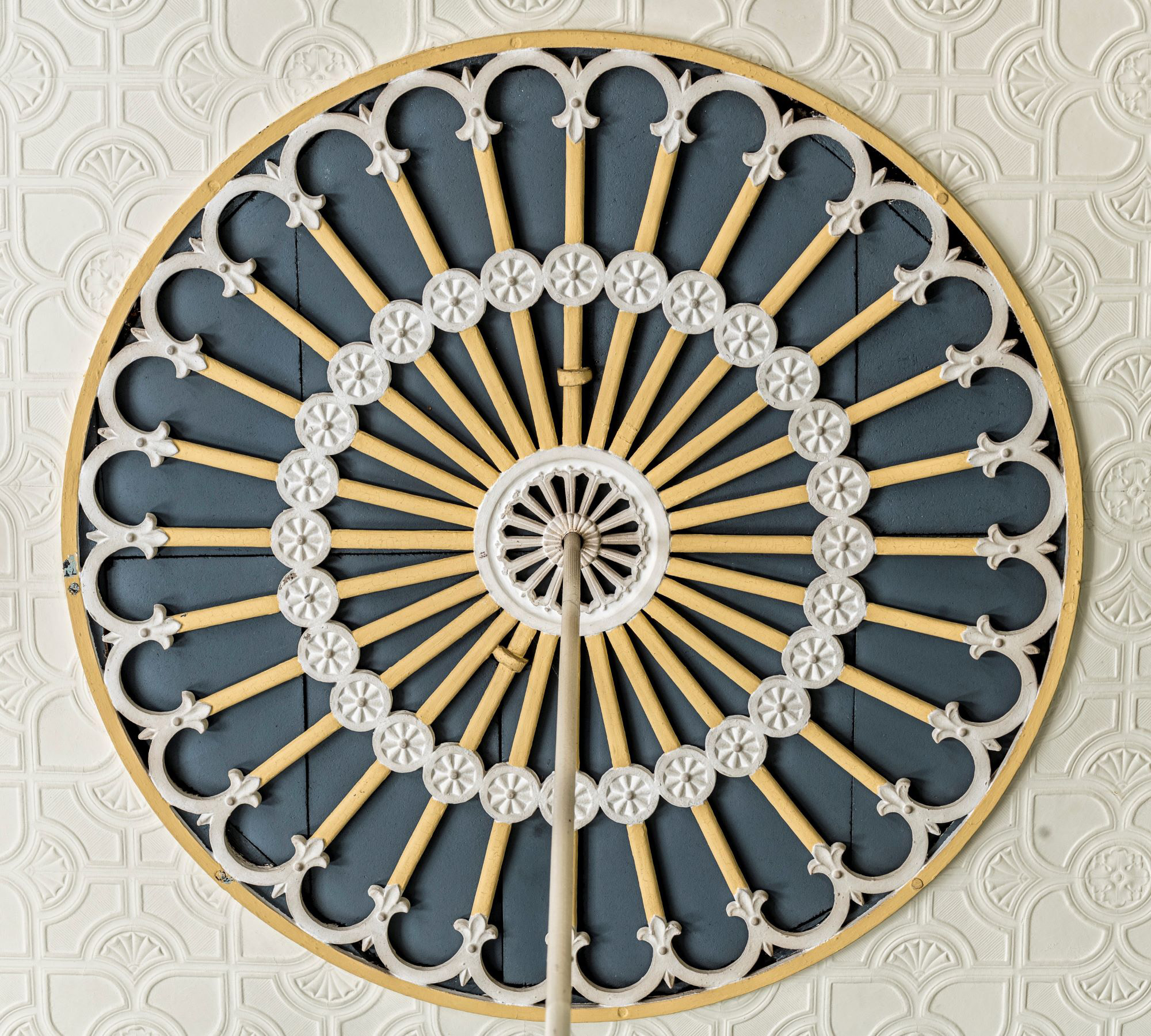 Decorative ceiling rose painted yellow and blue