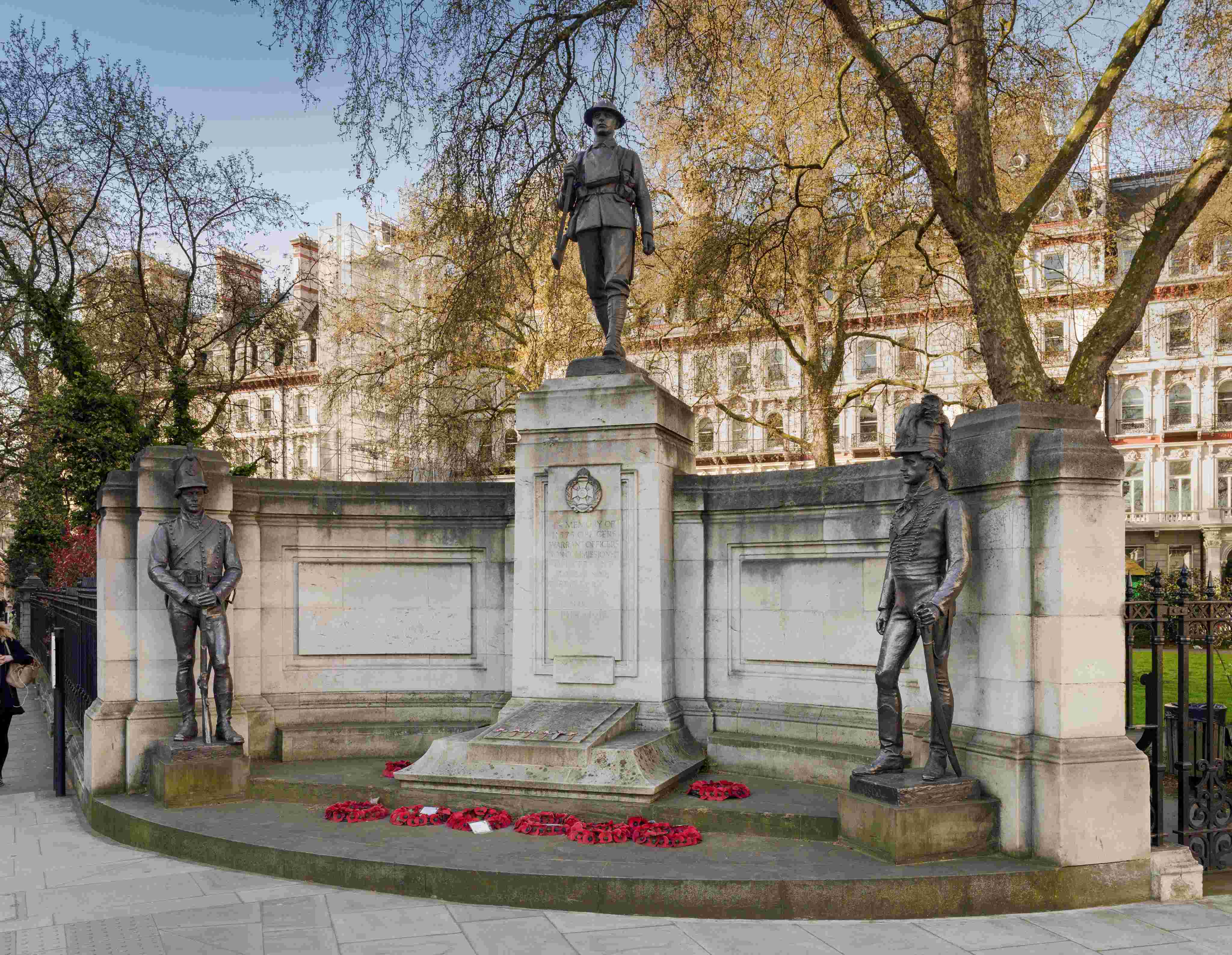 Image of The Rifle Brigade War Memorial, Grosvenor Gardens, Westminster, London, newly upgraded to II*. John Tweed, a leading sculptor of his day, here created a memorial which linked modern bravery with the illustrious past of this regiment: the marching Tommy is flanked by statues of a Napoleonic Rifleman and officer, alluding to the volunteer unit’s proud history. It lost 11,575 men over the course of the First World War.