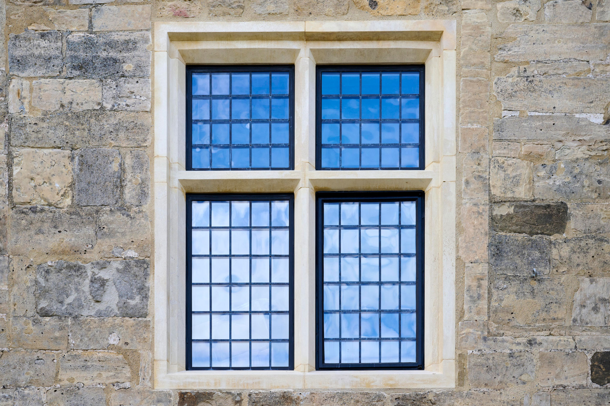 Exterior detail of a replacement stone window at a country house.