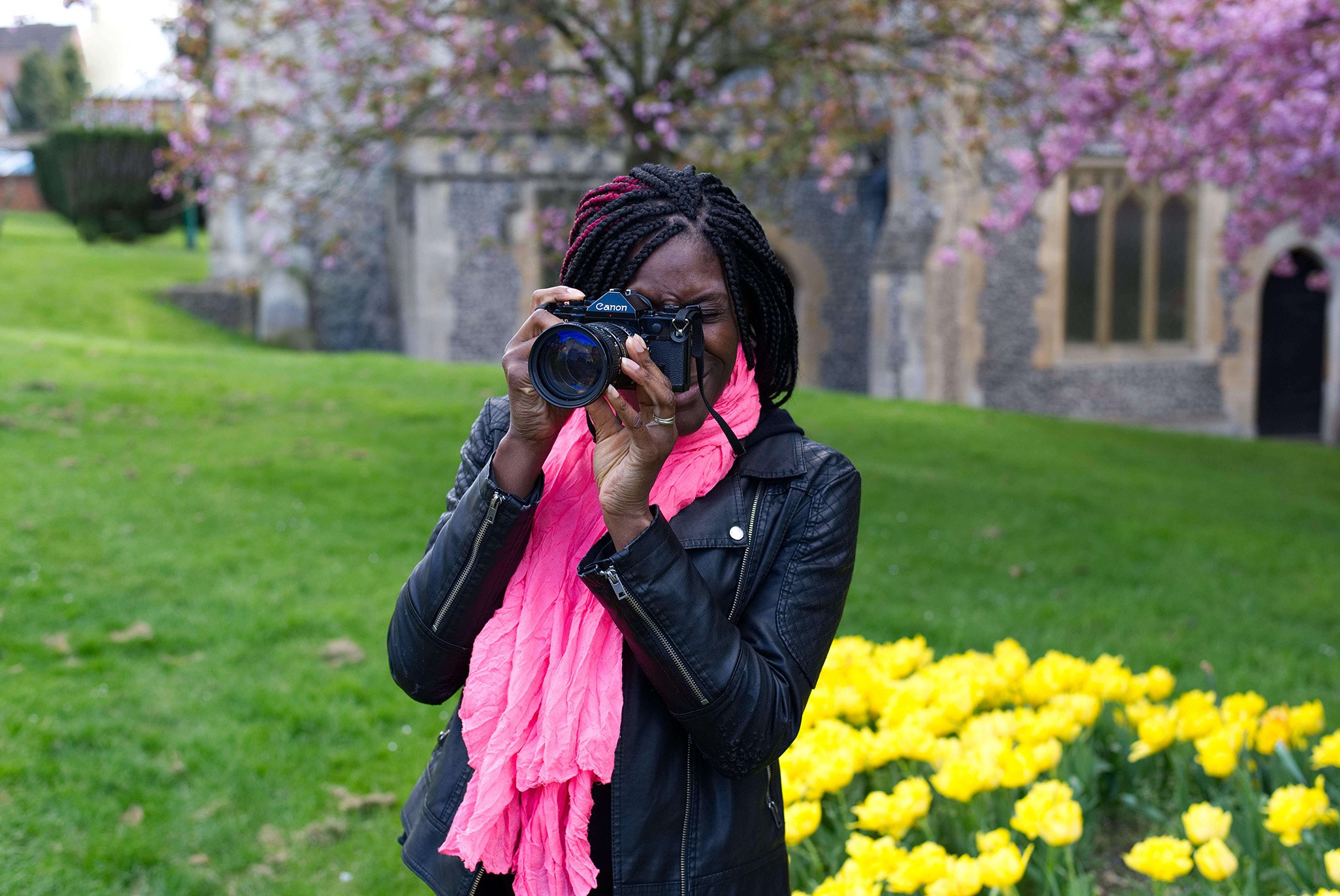 Woman with a camera in a church grounds