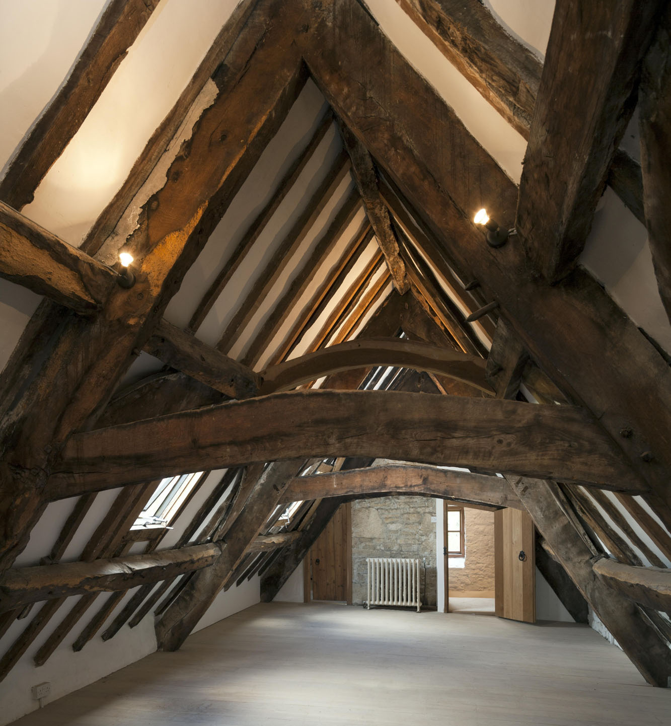 Attic room with exposed beams in an old house.