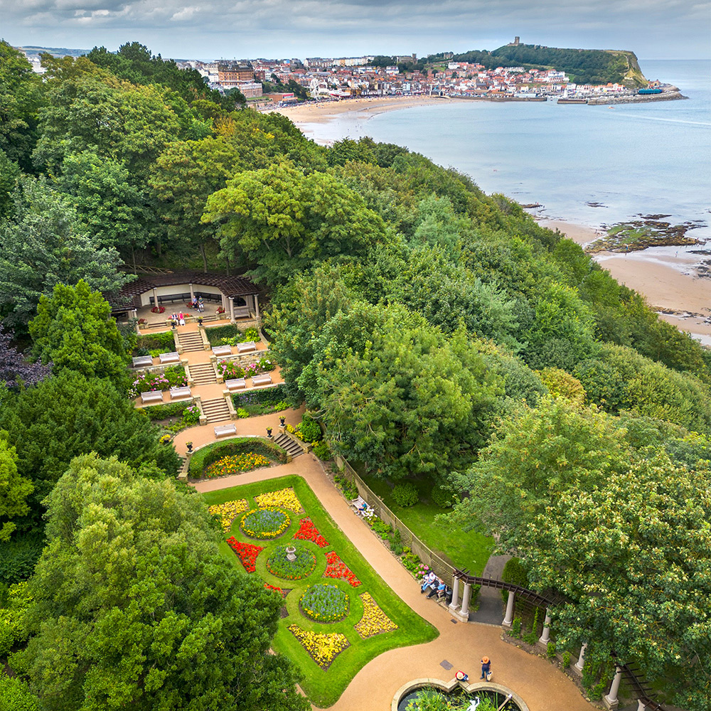 View of gardens beside a beach from above. 