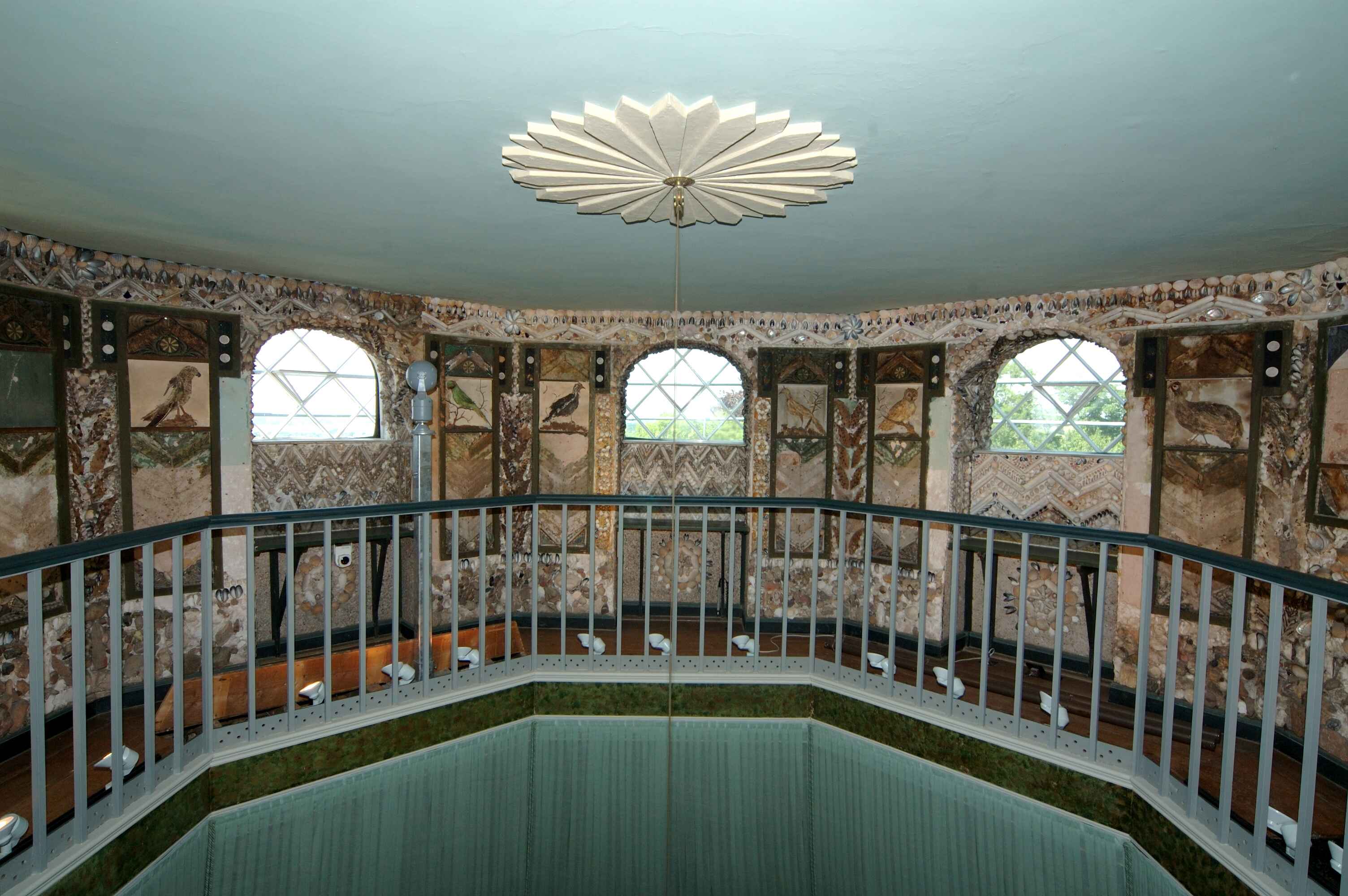 Gallery with railings and walls decorated with shells