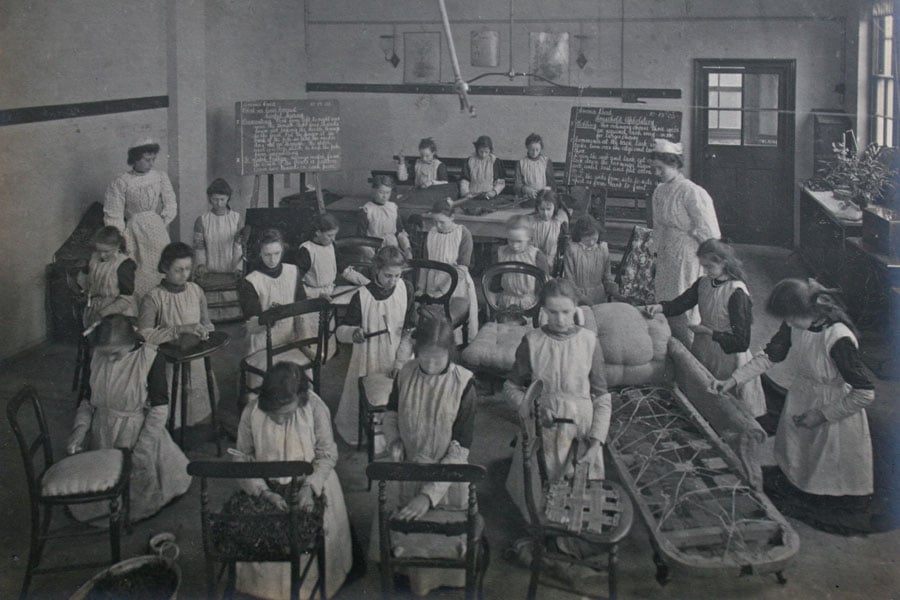 An upholstery class at Ancona Road, Woolwich, London Half Time Class for girls who worked part time and attended school part time, c.1890-1905. © & source The Women’s Library.