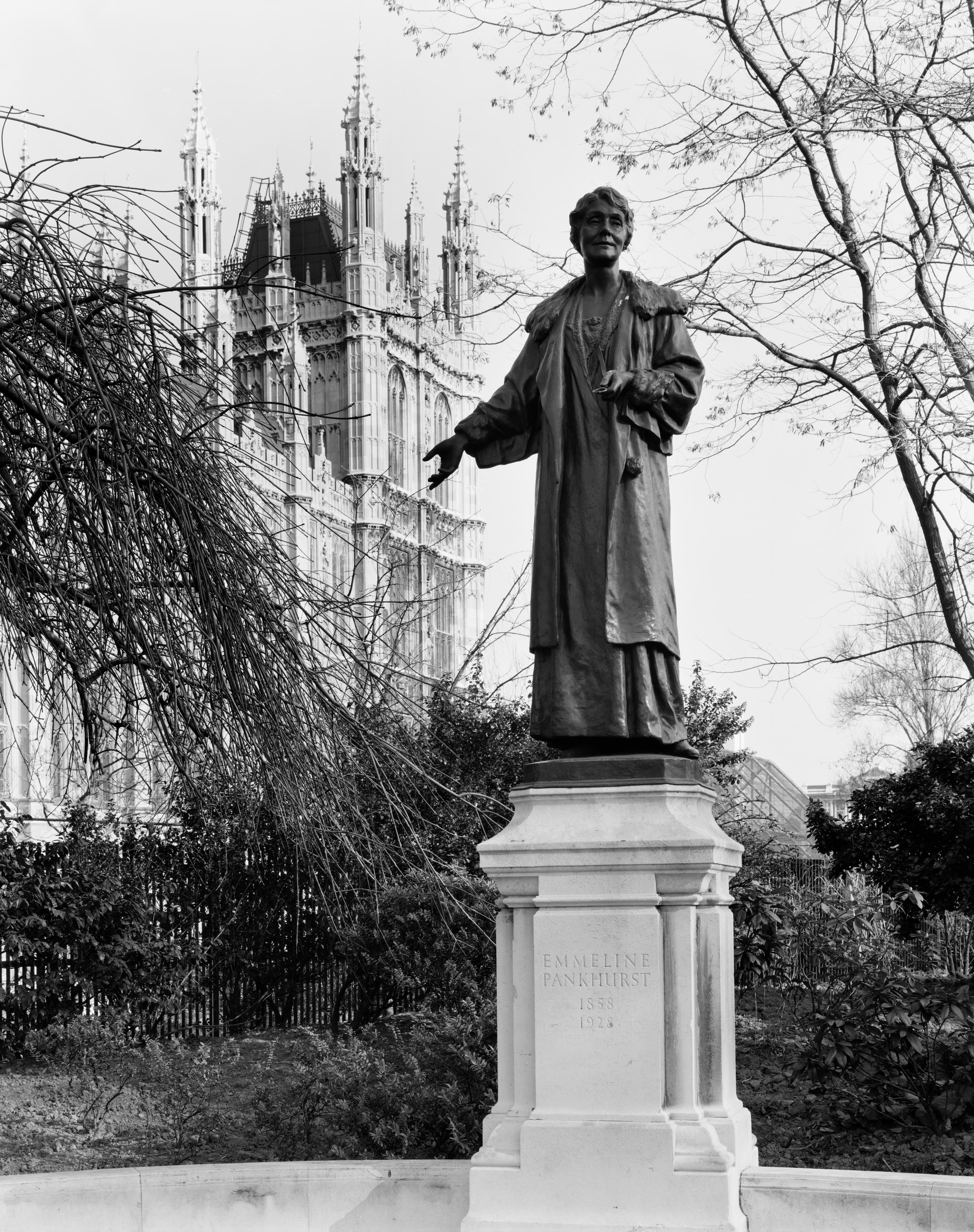 Statue of Emmeline Pankhurst with the spires of Westminster in the background.