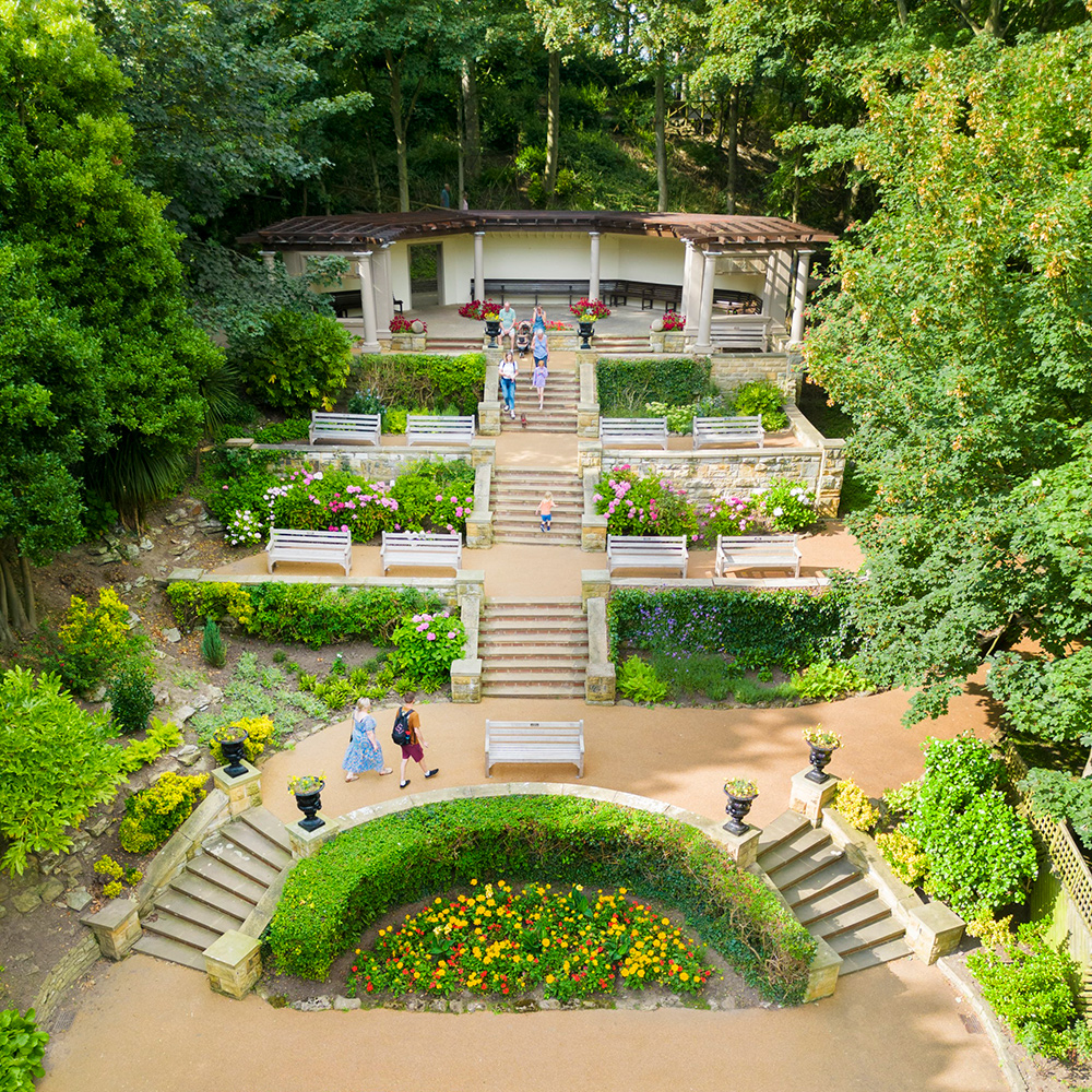 Italianate Garden, laid out on a curve and articulated by steps so that the topography and levels are maried to the natural form of the cliff. Access and views into and out of these gardens is designed to be limited. Drone view of garden and pavilion from south.