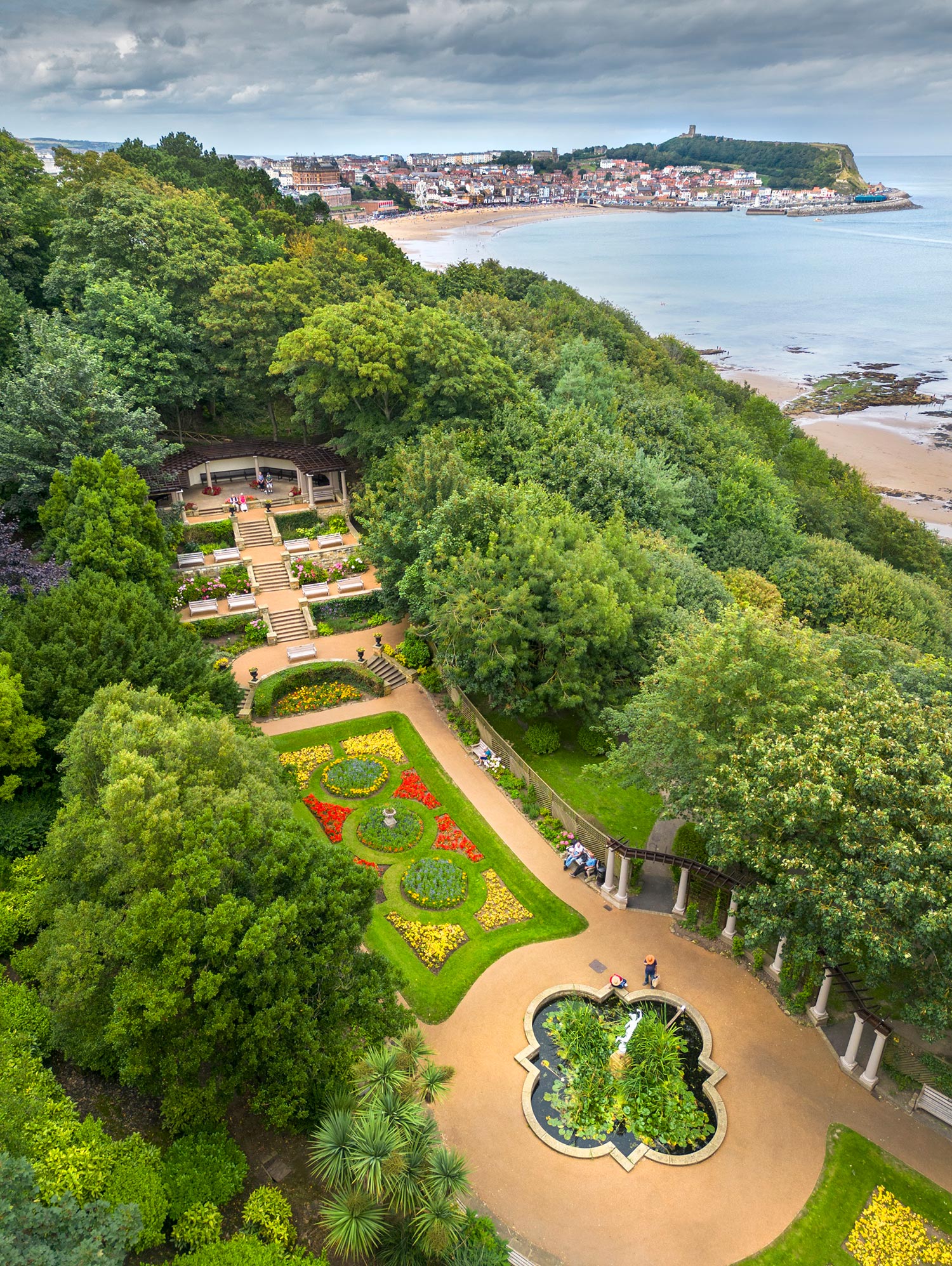 An image of a landscaped garden with the coastline in the background. 
