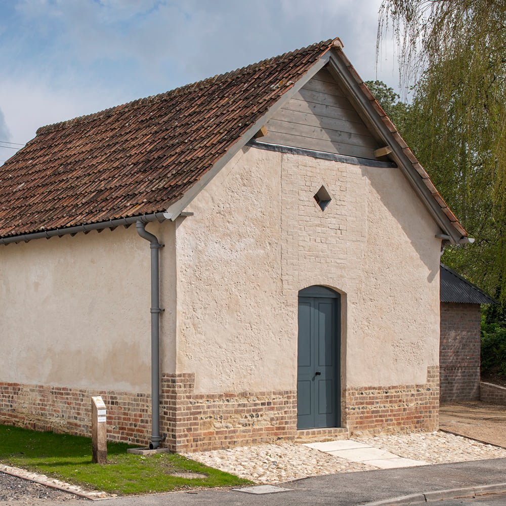 Corner view of a smart rendered brick chapel with no adornments. 