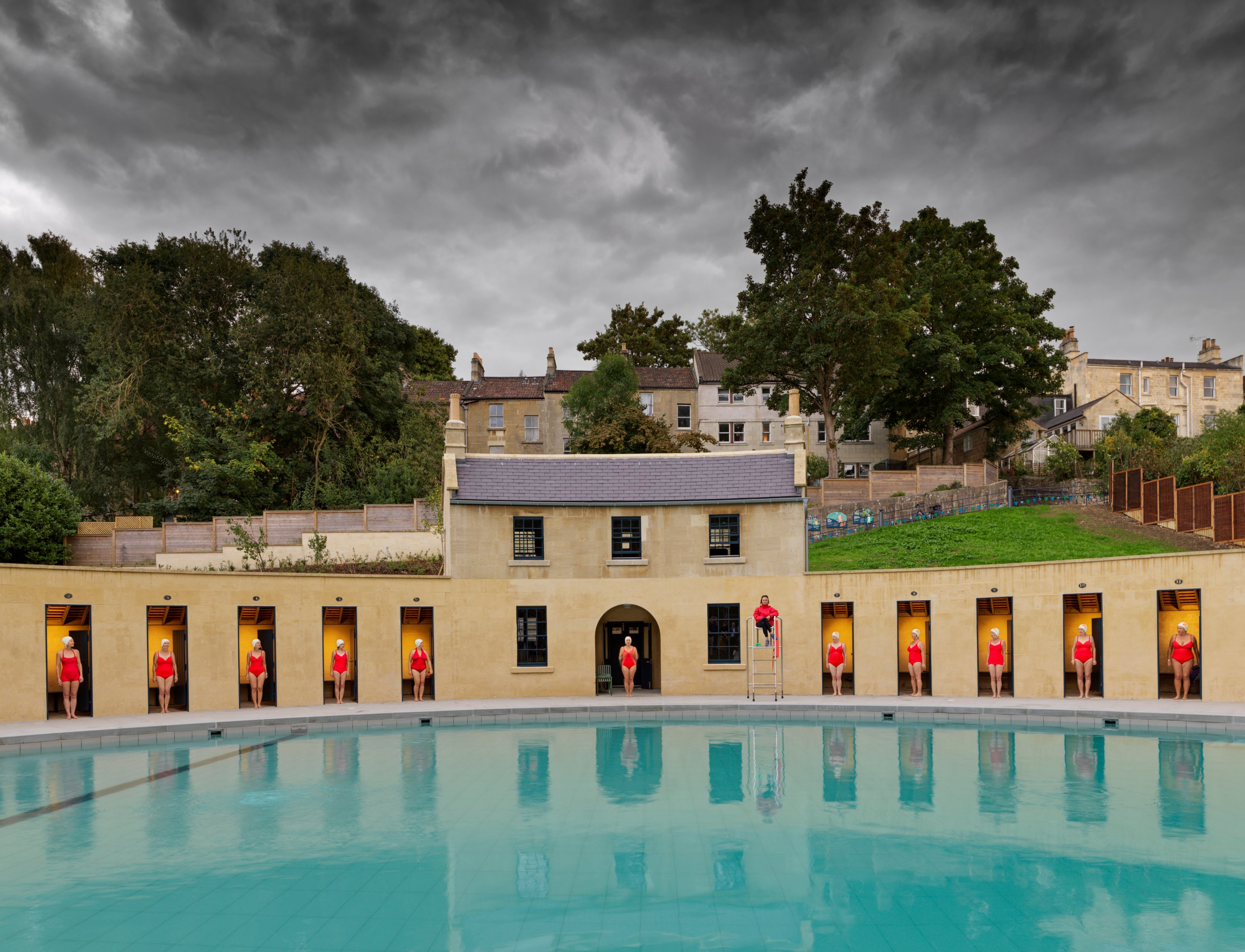 General view showing crescent and former caretakers cottage with members of Almost Synchro - synchronised swimming team. 